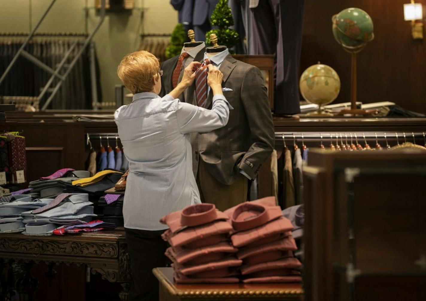 Carol Einertson straightened a tie on a display in the men's section at the new Von Maur store in Roseville, Minn., on Wednesday, October 4, 2018.