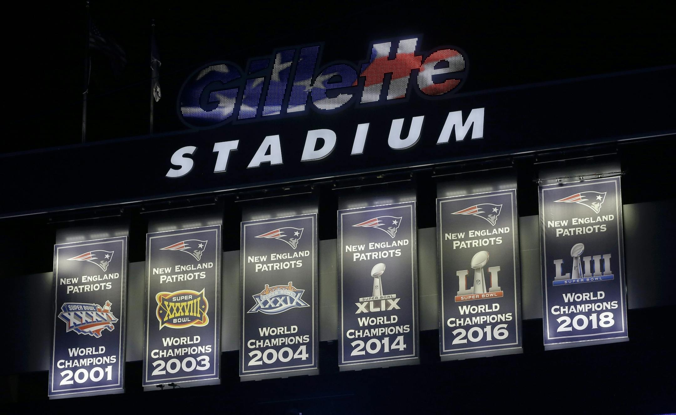 The New England Patriots unveil a sixth banner, right, commemorating the team's Super Bowl 53 victory before an NFL football game against the Pittsburgh Steelers, Sunday, Sept. 8, 2019, in Foxborough, Mass. (AP Photo/Steven Senne)