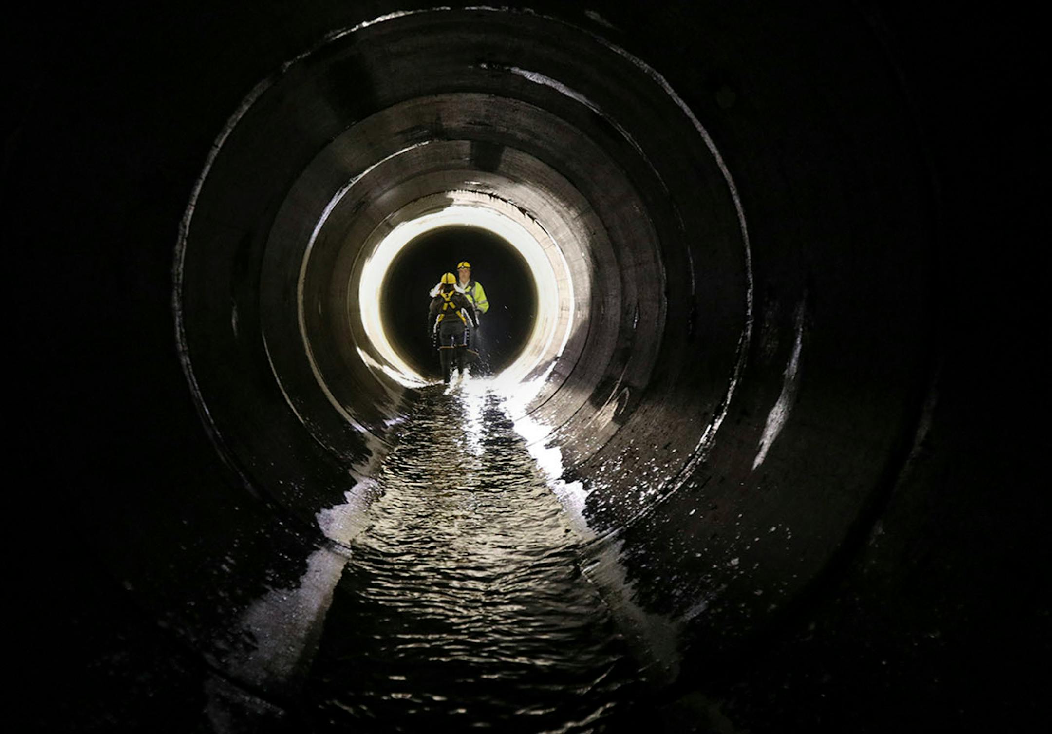 Sewer engineer Joe Klejwa spoke with Katrina Kessler, director of Surface Water and Sewers for the Minneapolis Public Works Department, during a tour underground in the northeast.