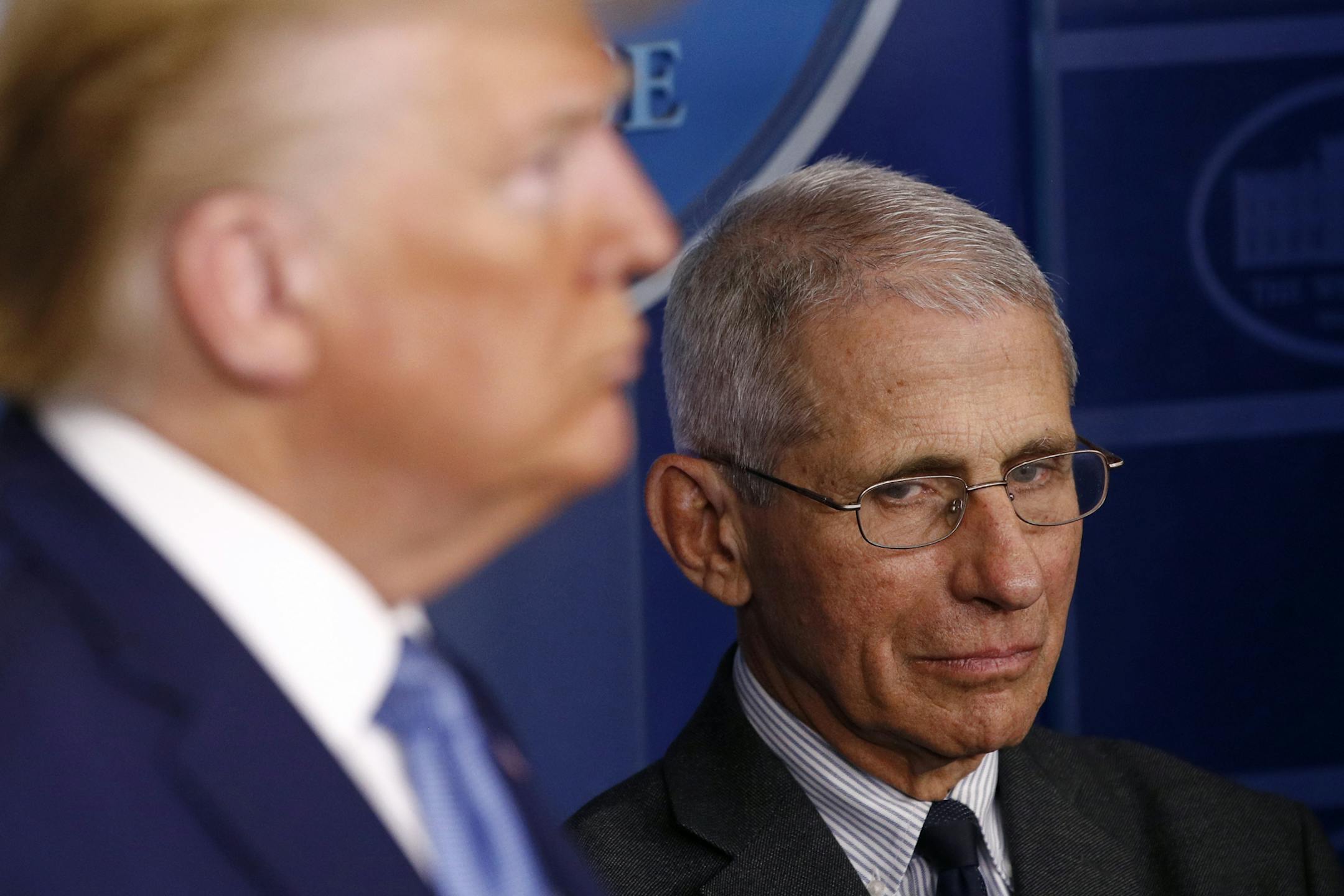 Director of the National Institute of Allergy and Infectious Diseases Dr. Anthony Fauci, right, and President Donald Trump listen as Vice President Mike Pence speaks during a coronavirus task force briefing at the White House, Saturday, March 21, 2020, in Washington. (AP Photo/Patrick Semansky) ORG XMIT: DCPS108