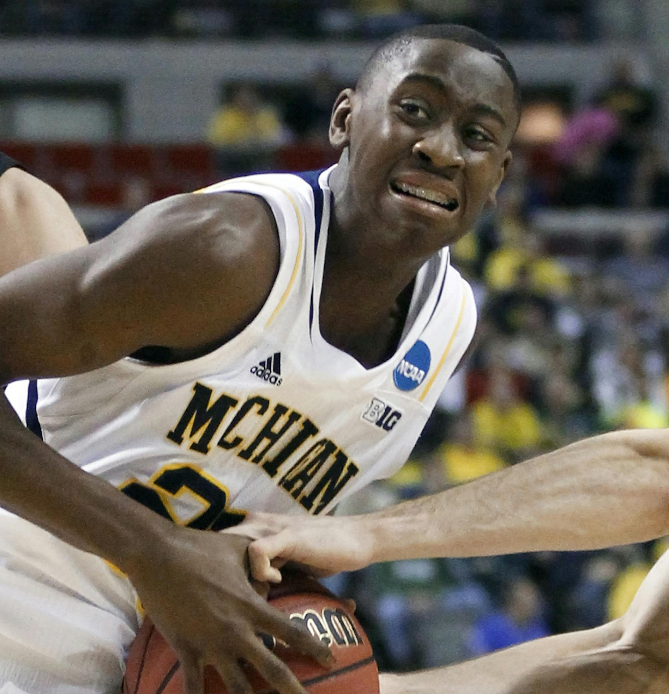 South Dakota State guard Brayden Carlson, right, tries to steal the ball from Michigan guard Caris LeVert diuring the first half of a second-round game of the NCAA men's college basketball tournament Thursday, March 21, 2013, in Auburn Hills, Mich. (AP Photo/Duane Burleson) ORG XMIT: DTP144