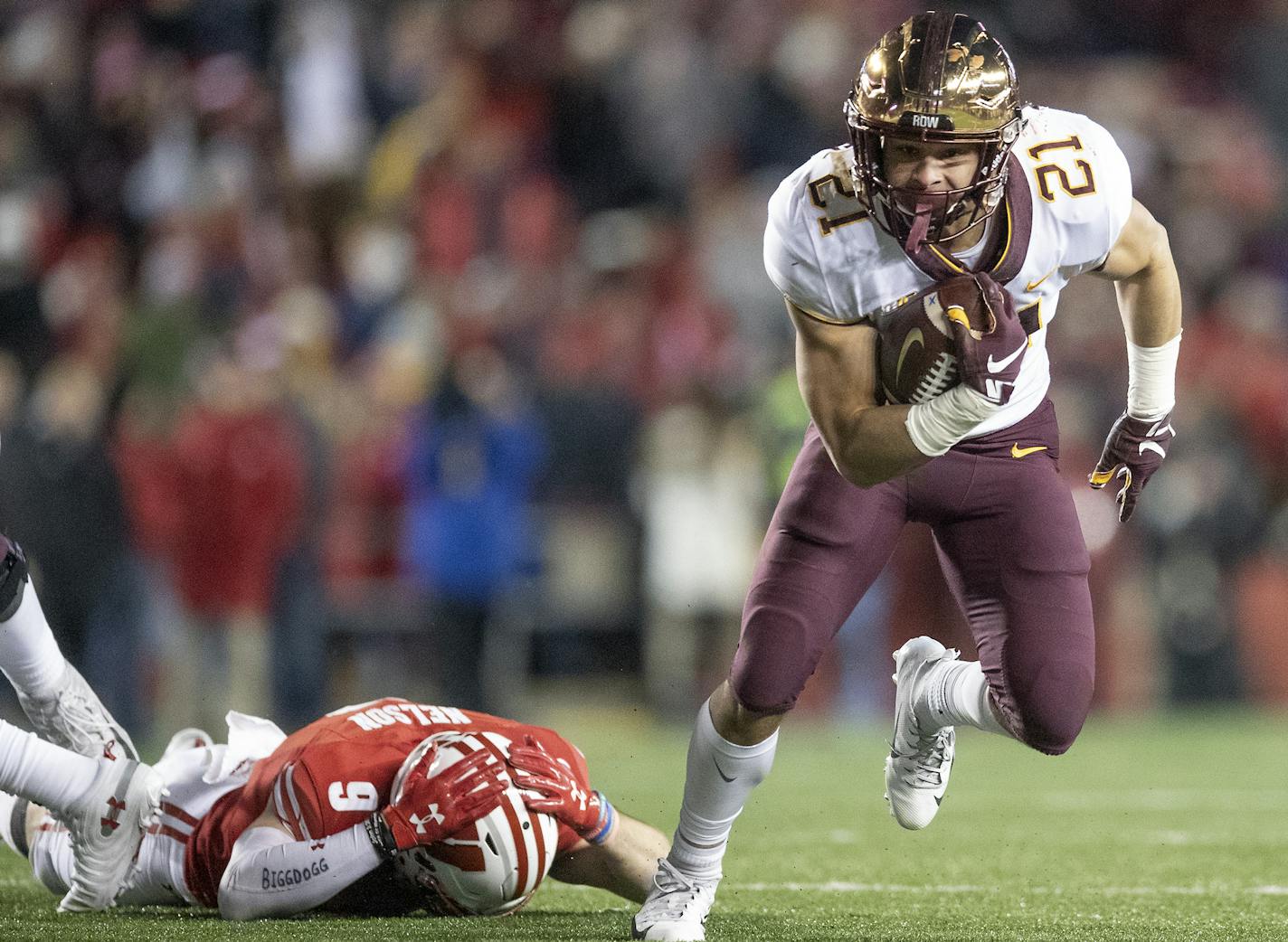 Minnesota's running back Bryce Williams broke away from Wisconsin's safety Scott Nelson to run to the end zone for a touchdown during the fourth quarter at Camp Randall Stadium, Saturday, November 24, 2018 in Madison, Wis. It's the 128th meeting between the two teams. ] ELIZABETH FLORES &#xef; liz.flores@startribune.com