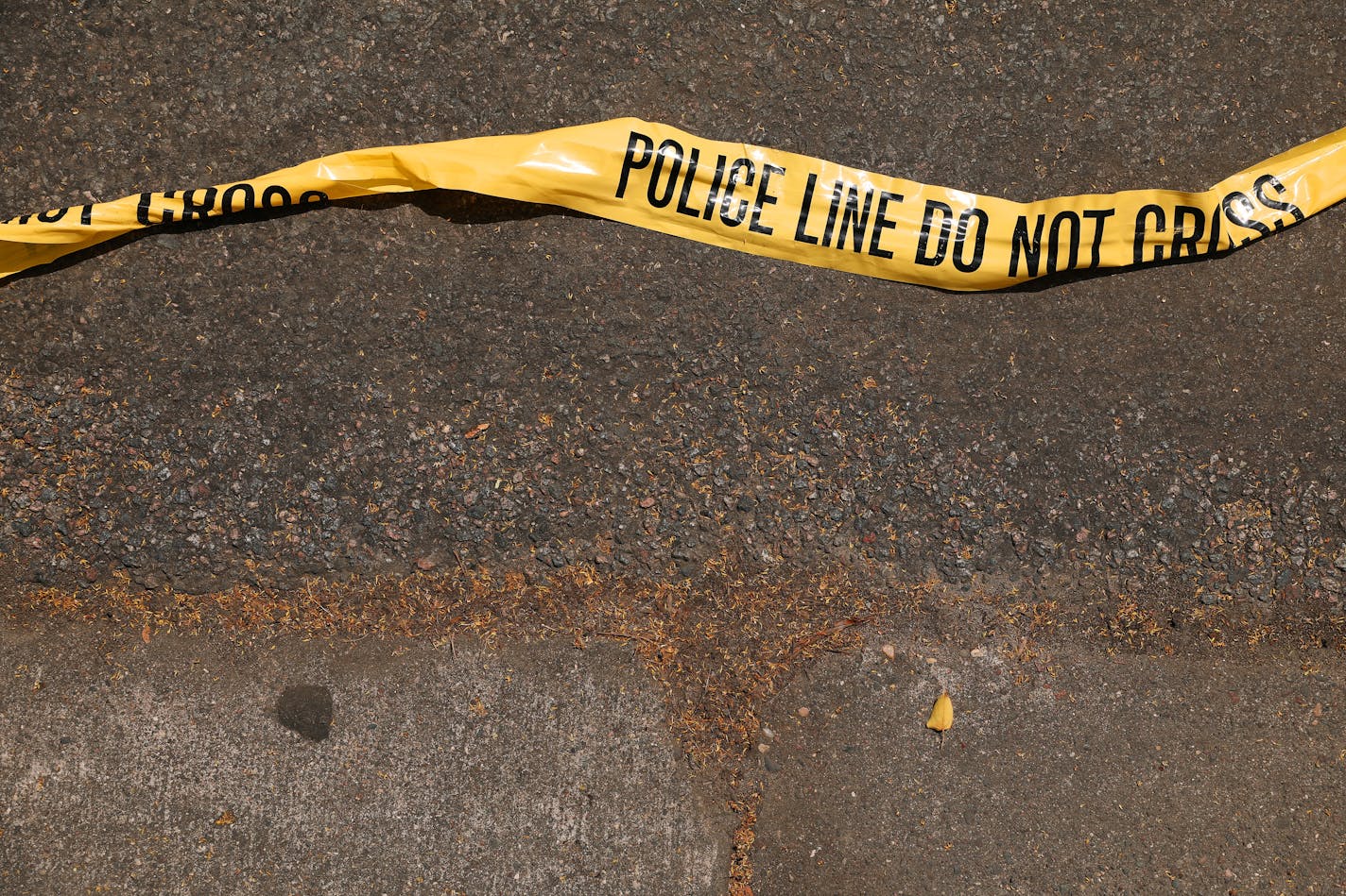 Police tape lay on the street