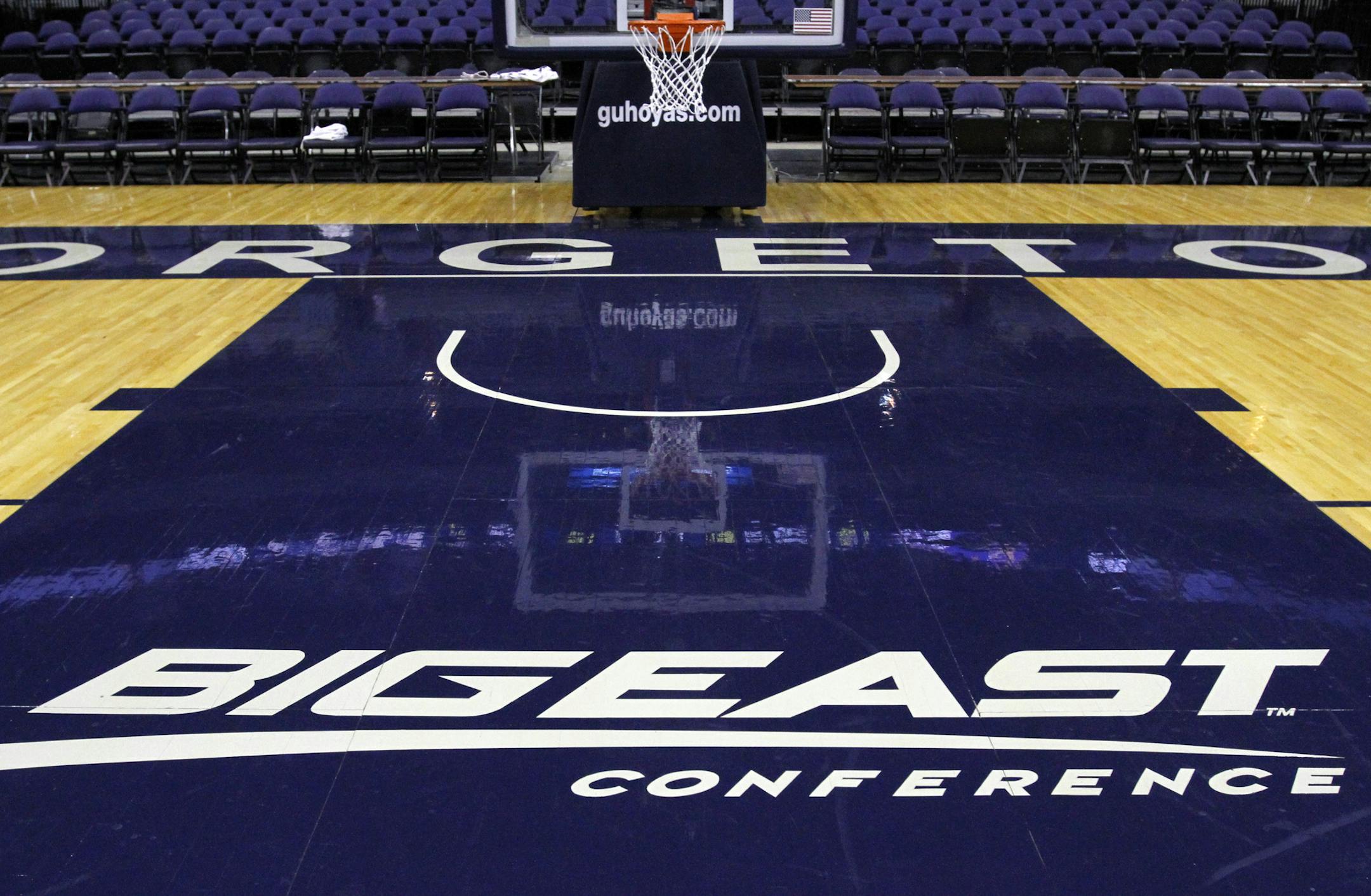 FILE - In this Dec. 15, 2012, file photo, a Big East Conference logo is displayed on the court after Georgetown played Western Carolina in an NCAA college basketball game at the Verizon Center in Washington. Big East football schools will get almost all of a $110 million pot in a deal that will allow seven departing basketball schools to keep the name Big East and start playing in their own conference next season, a person familiar with the negotiations says. The basketball schools, which includ