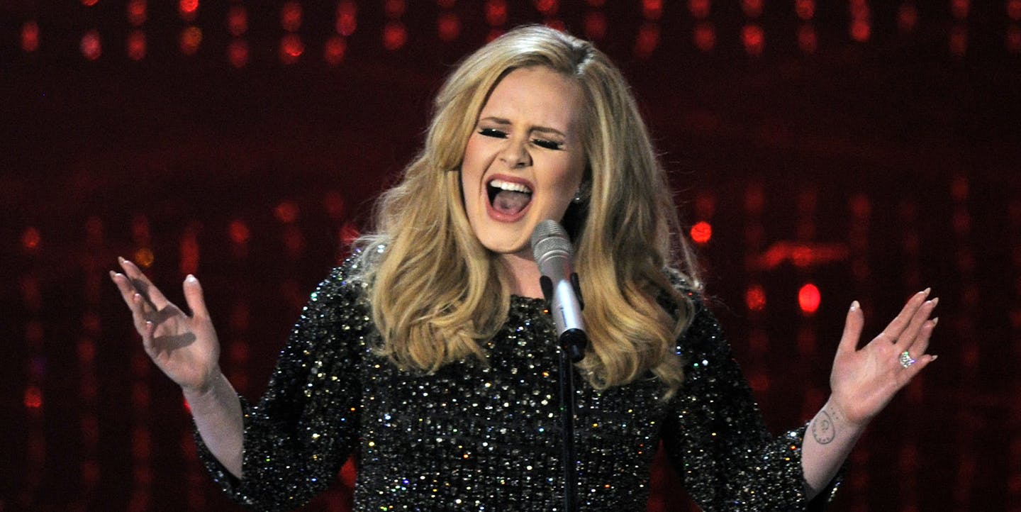 FILE - In this Feb. 24, 2013 file photo, Adele performs during the Oscars at the Dolby Theatre in Los Angeles. NBC said Friday, Oct. 30, 2015, that the singer will tape a concert at New York's Radio City Music Hall in November, to be shown in a one-hour prime-time special on Dec. 14. The Grammy Award-winner just released her new song "Hello" with a full album upcoming. (Photo by Chris Pizzello/Invision/AP) ORG XMIT: MIN2015112312530623