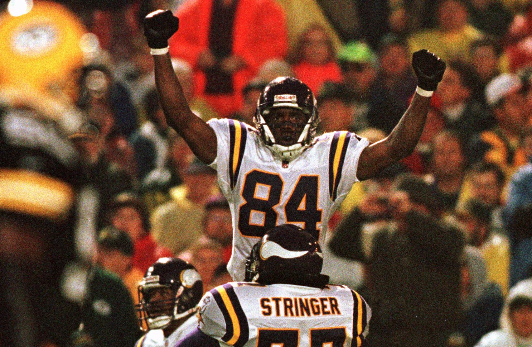 The Vikings' Randy Moss (84) celebrated in the arms of tackle Korey Stringer after catching a touchdown pass against Green Bay.