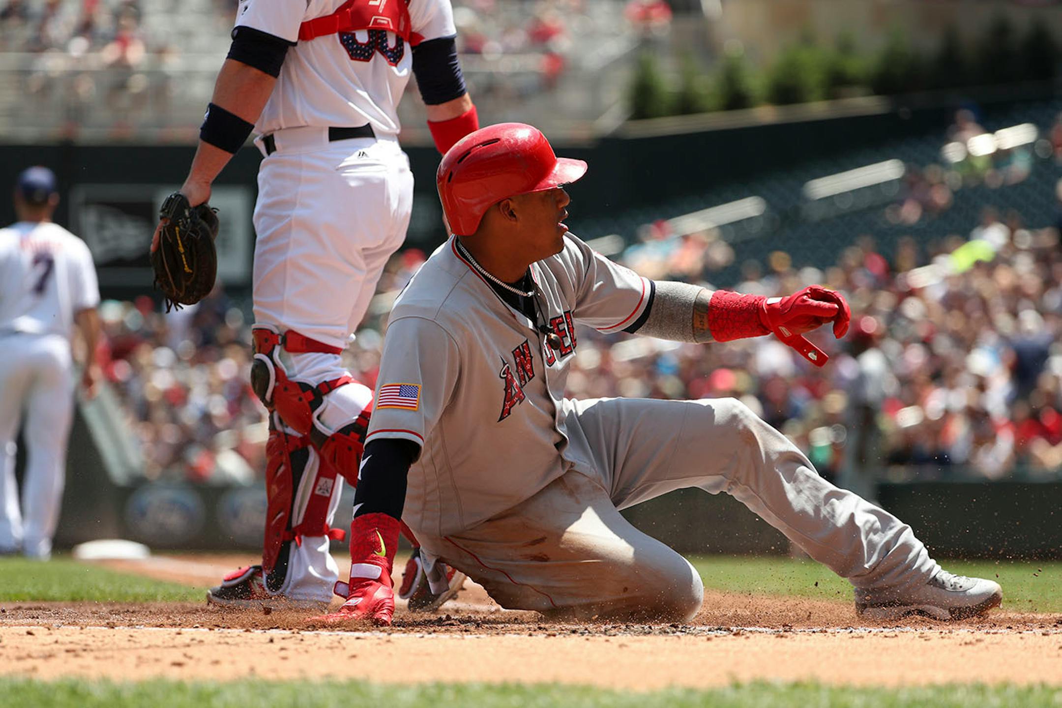 Los Angeles Angels third baseman Yunel Escobar (0) scored past Minnesota Twins catcher Chris Gimenez (38) in the second inning.