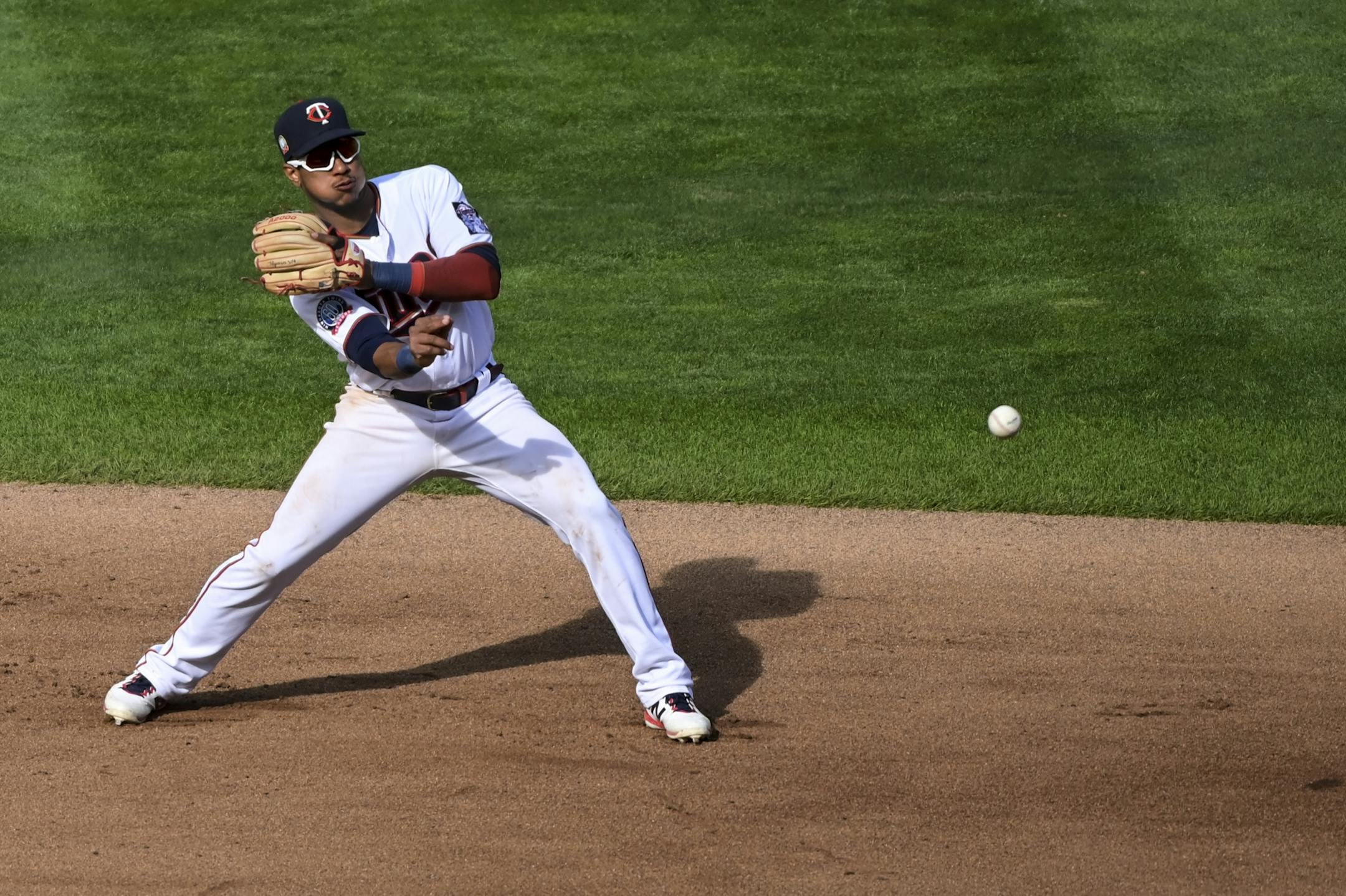 Minnesota Twins shortstop Jorge Polanco (11) threw to first after fielding a ground ball hit by Kansas City Royals shortstop Adalberto Mondesi (27) for a forced out in the top of the fourth inning.