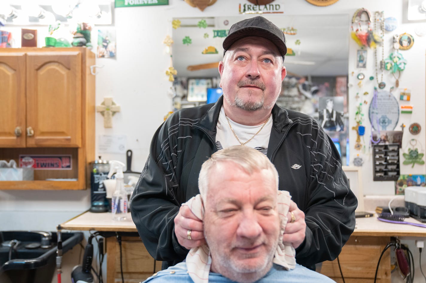 Dennis Manning cuts Robert Langle's hair Tuesday, Nov. 07, 2023, at Sportsmen's Barbers in Columbia Heights, Minn. The barbershop is being forced to vacate after 22 years with the landlord not renewing the lease and preparing to sell it to a music school. ]