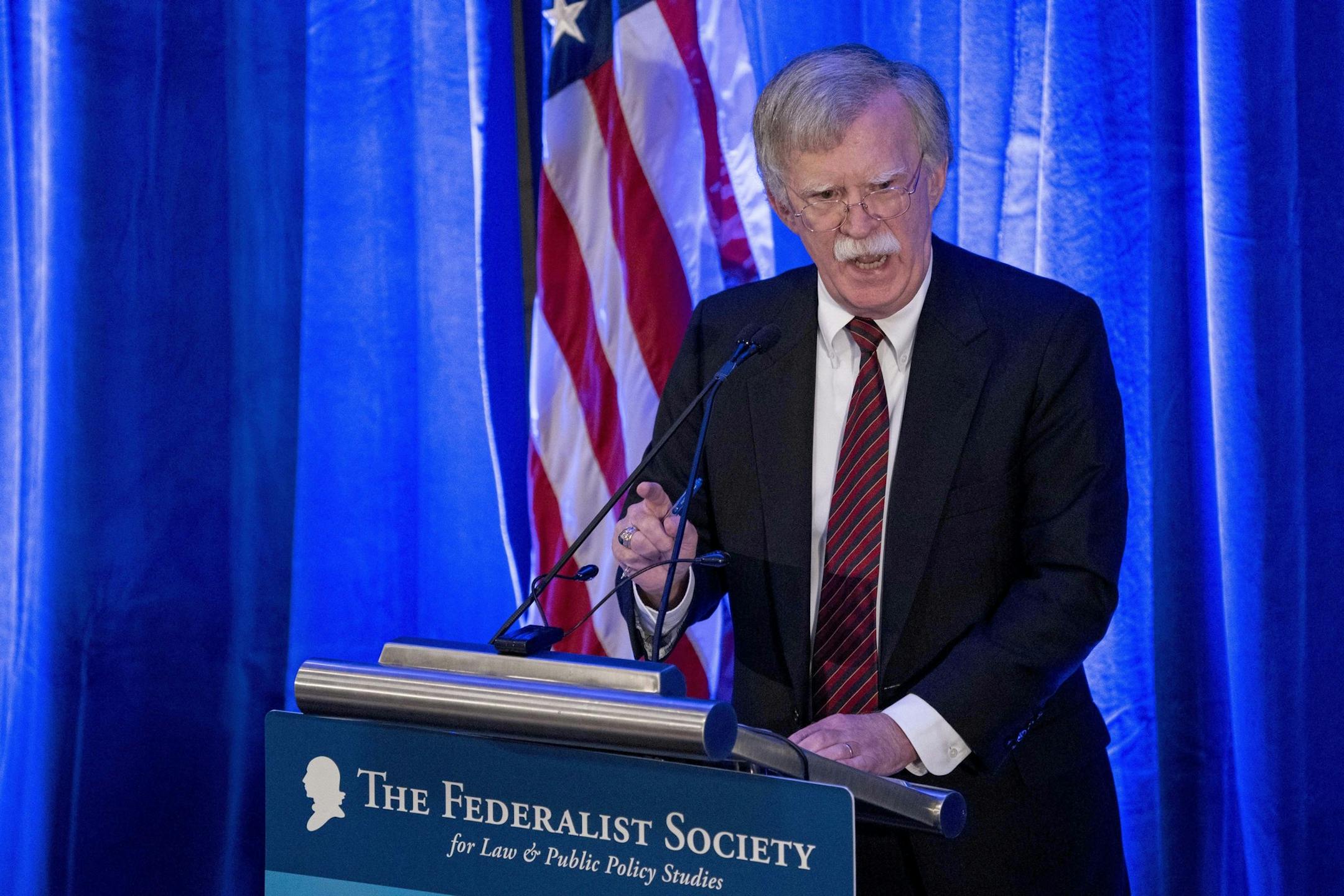 FILE - In this Monday, Sept. 10, 2018 file photo, National Security Adviser John Bolton speaks at a Federalist Society luncheon at the Mayflower Hotel, in Washington. Afghan rights workers are warning that Bolton's blistering attack on the International Criminal Court investigating war crimes allegations will strengthen a climate of impunity in Afghanistan, prolong the war and embolden those carrying out acts of violence. In a speech Monday, Bolton said Washington would not cooperate with The Ha