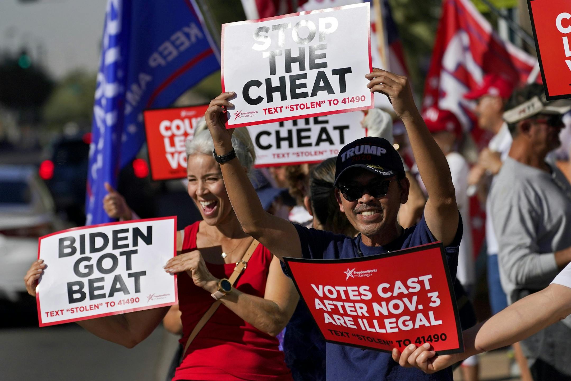 People rally outside City Hall, Thursday, Nov. 5, 2020, in Phoenix. Dozens of pro-Trump protesters gathered to protest after Democratic challenger Joe Biden was reported to have flipped the Republican stronghold of Arizona.