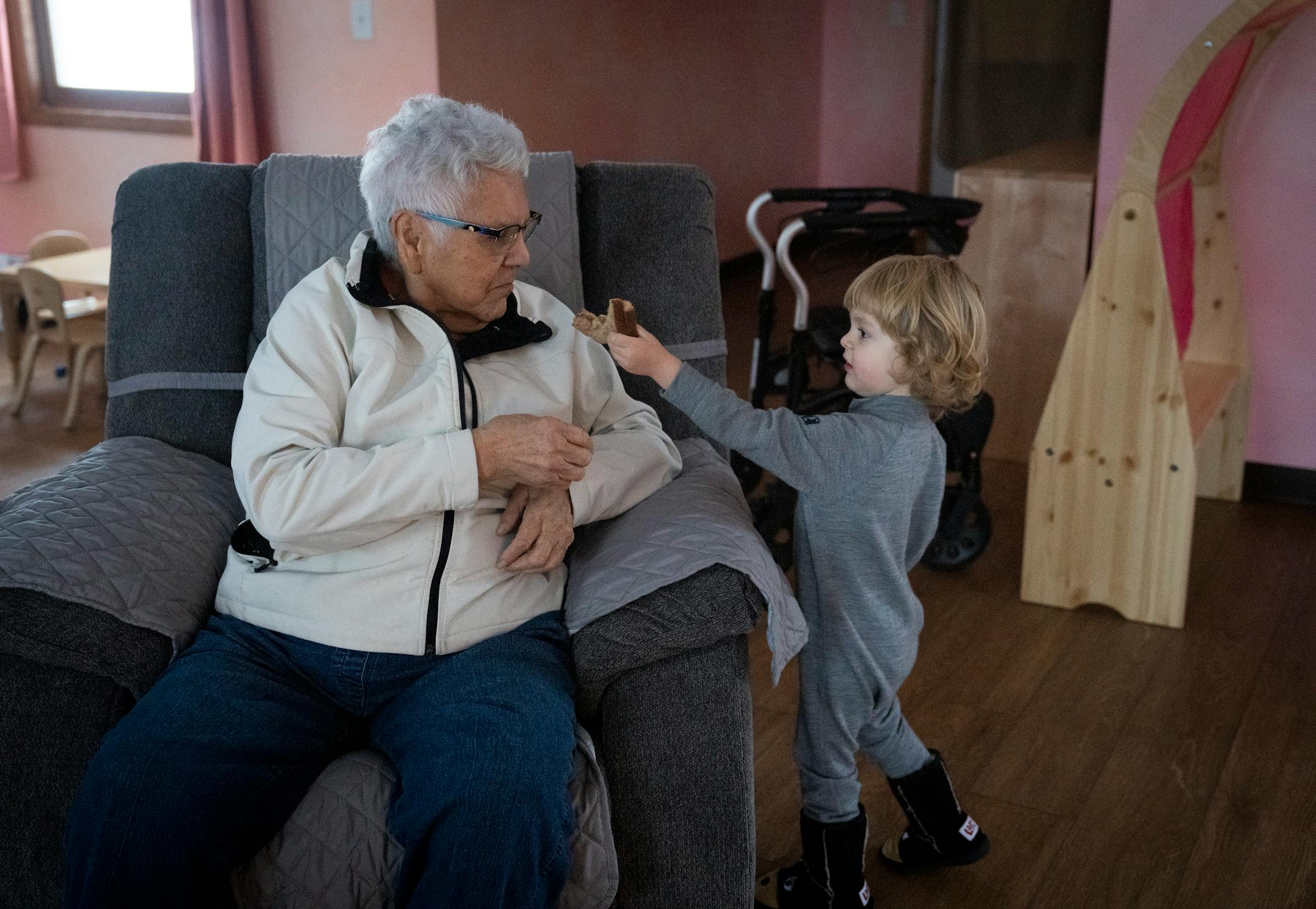 Elder Nigigoonsiminikaaning Nancy Jones chatted in Ojibwe with Ogimaagaabaw Patrick Linehan as she visited with children as part of the Ojibwe immersion program.