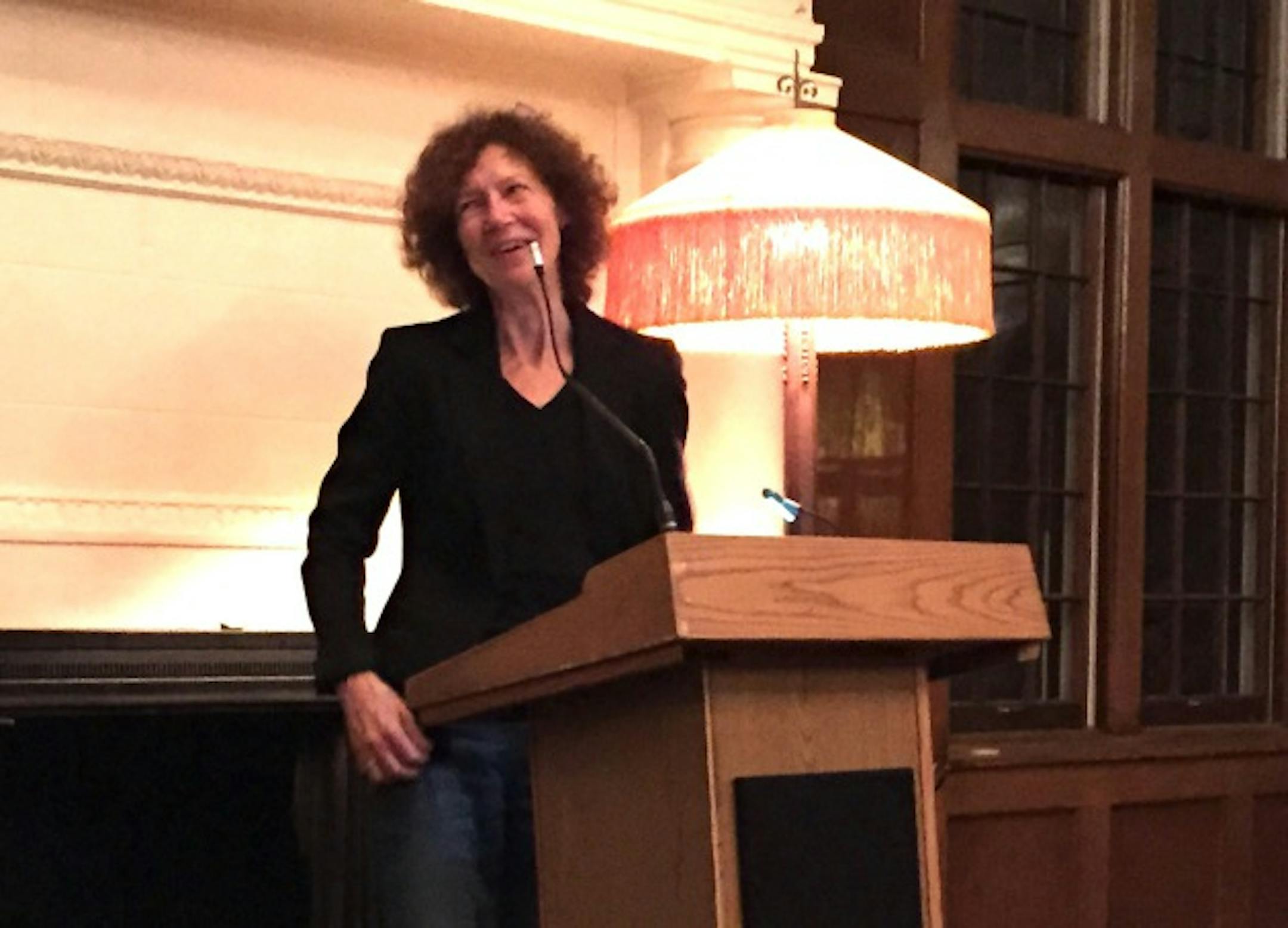 Joyce Sutphen jokes with emcee Danny Klecko.