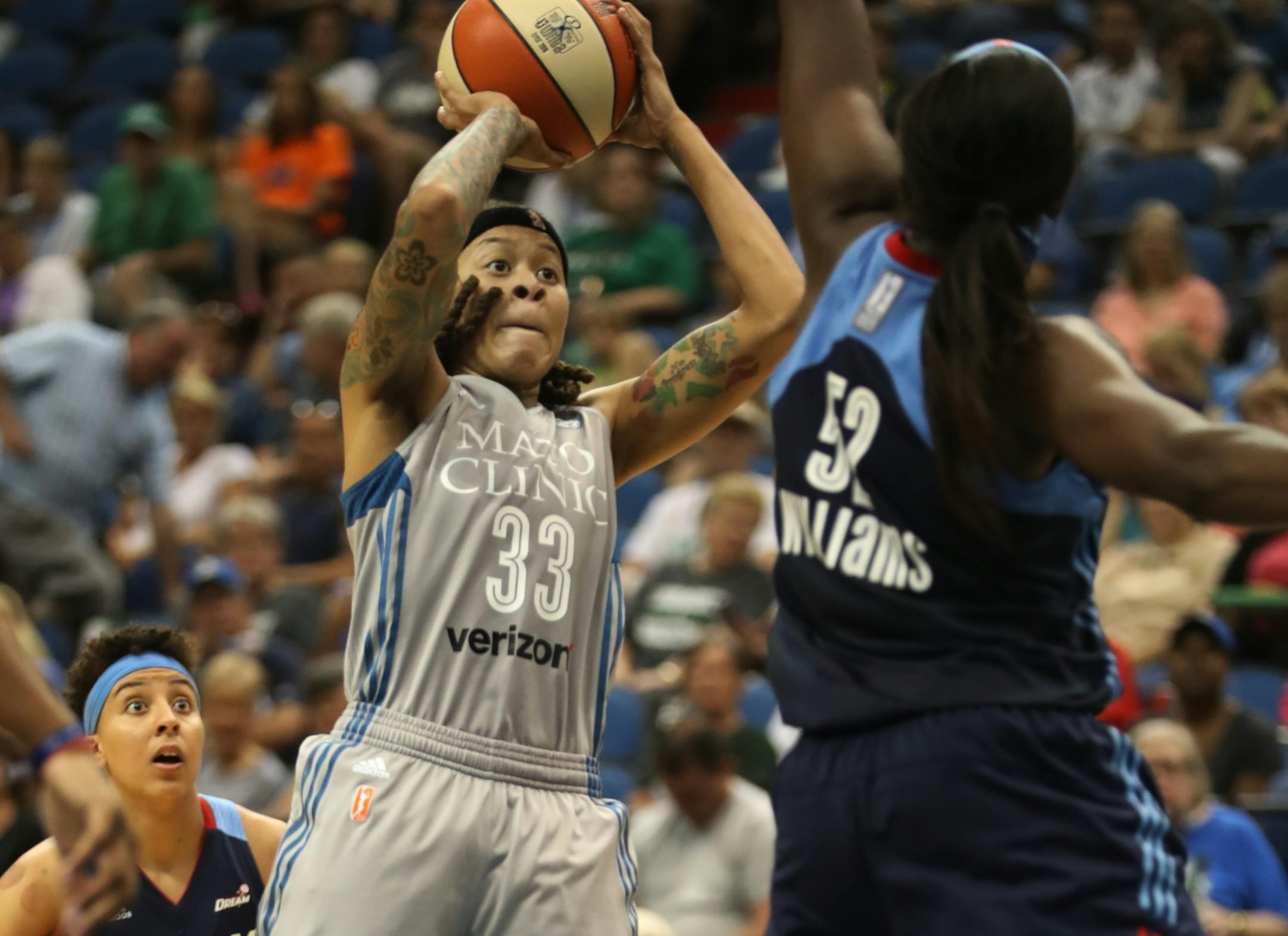 Seimone Augustus(33) shoots over Dream player Bria Holmes(32).