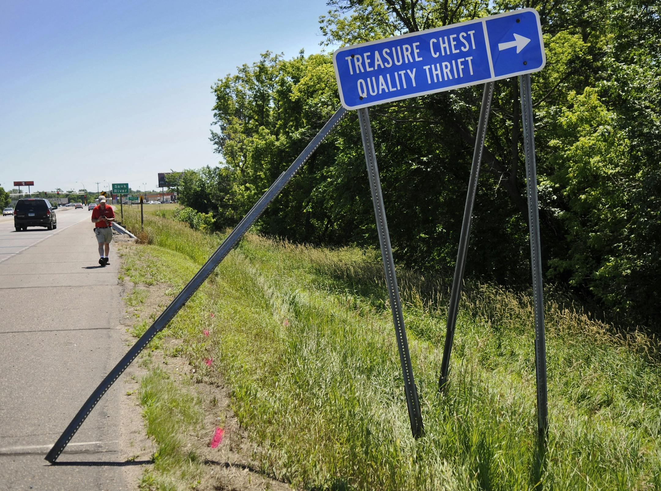 A sign sits askew Monday on Stearns County Road 75, a telltale clue that led a Stearns County Sheriff's Department deputy to a car overturned in the Sauk River in Waite Park, Minn. A man and two children died in the accident which happened overnight. Two other men riding in the vehicle were treated for what were believed non-life-threatening injuries.
