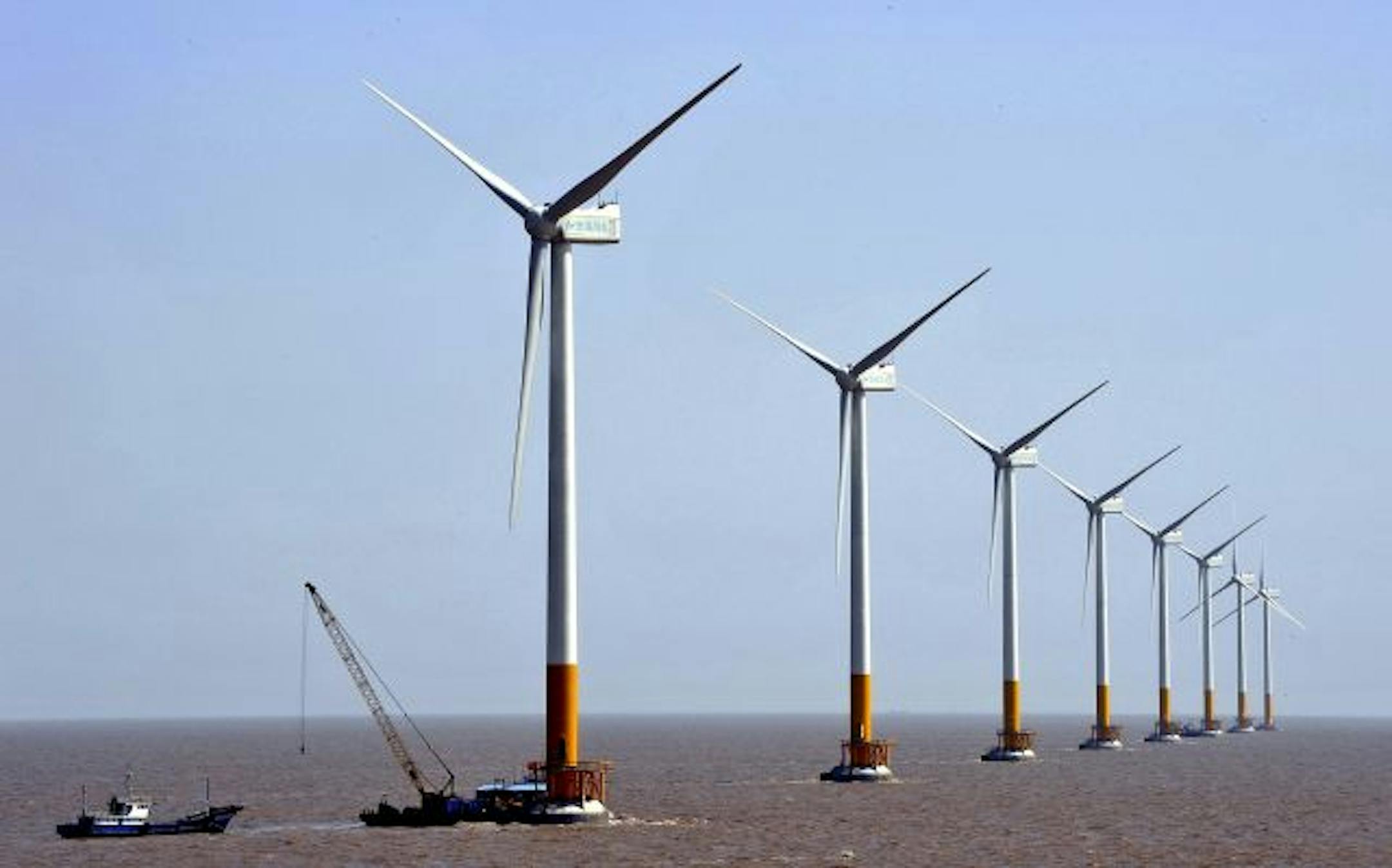 Wind turbines of the Donghai Bridge Offshore Wind Farm this month near Shanghai, China. The Chinese government will spend billions of dollars on building nuclear and solar power plants, wind farms and on research into renewable energy technology.