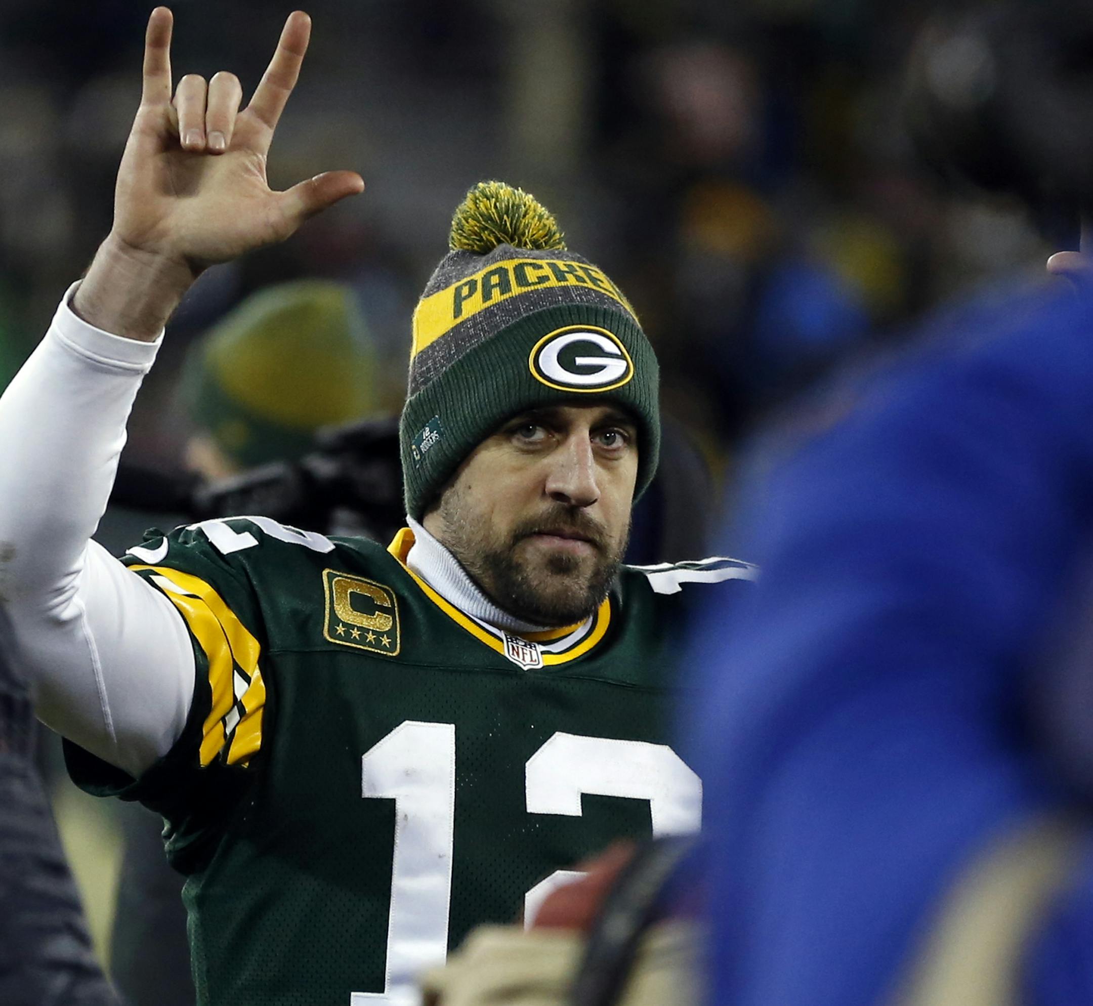 Green Bay Packers quarterback Aaron Rodgers (12) celebrates on the sideline during the second half of an NFC wild-card NFL football game, Sunday, Jan. 8, 2017, in Green Bay, Wis. The Packers won 38-13. (AP Photo/Matt Ludtke)