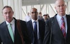 Former Minneapolis police officer Mohamed Noor, middle, is flanked by his attorneys Peter Wold, left, and Thomas Plunkett, right, on Tuesday, April 9,