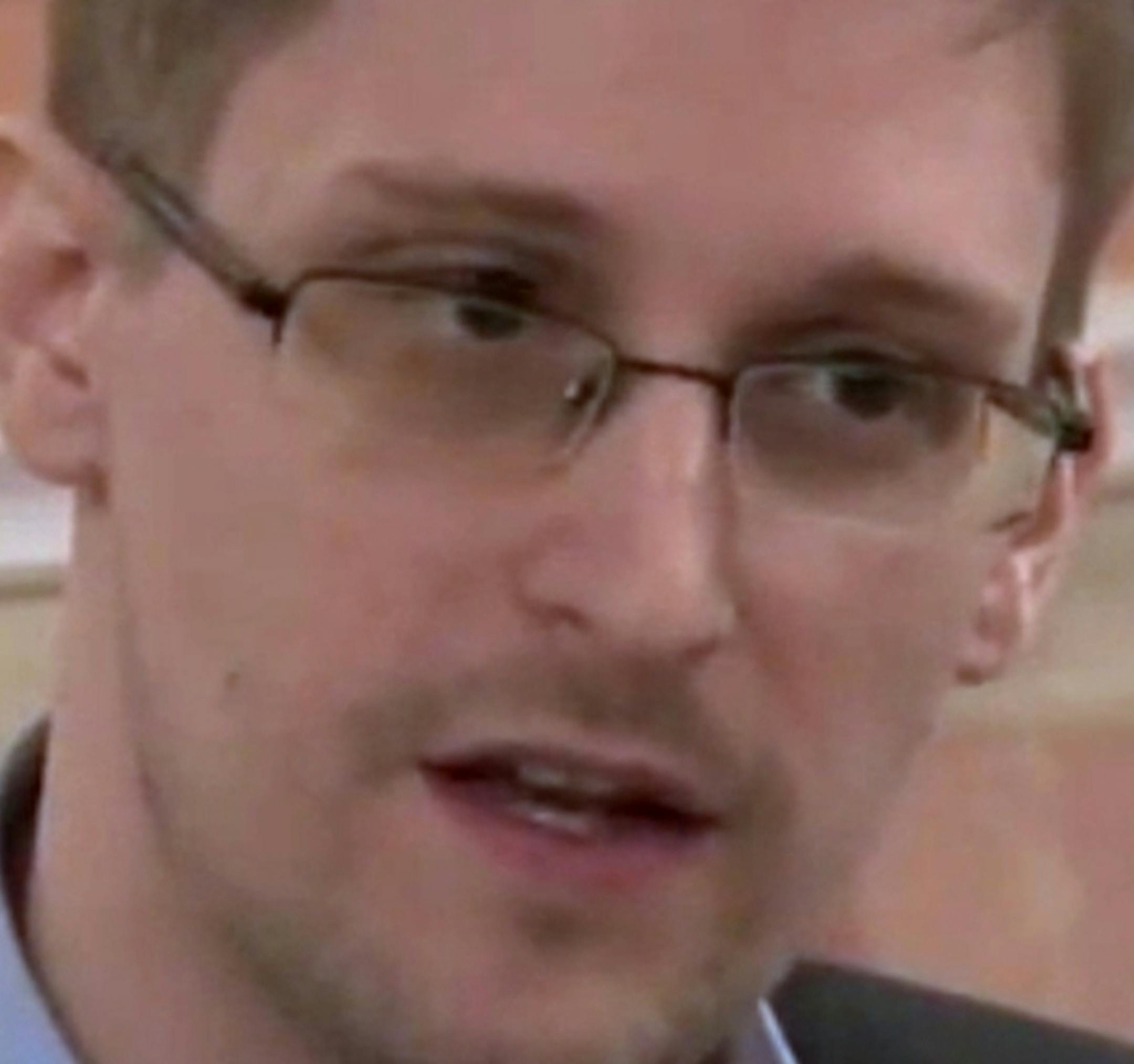 In this image made from video released by WikiLeaks on Friday, Oct. 11, 2013, former National Security Agency systems analyst Edward Snowden speaks during a presentation ceremony for the Sam Adams Award in Moscow, Russia. Should Snowden ever return to the U.S., he would face criminal charges for leaking information about NSA surveillance programs. But legal experts say a trial could expose more classified information as his lawyers try to build a case in an open court that the operations he expo