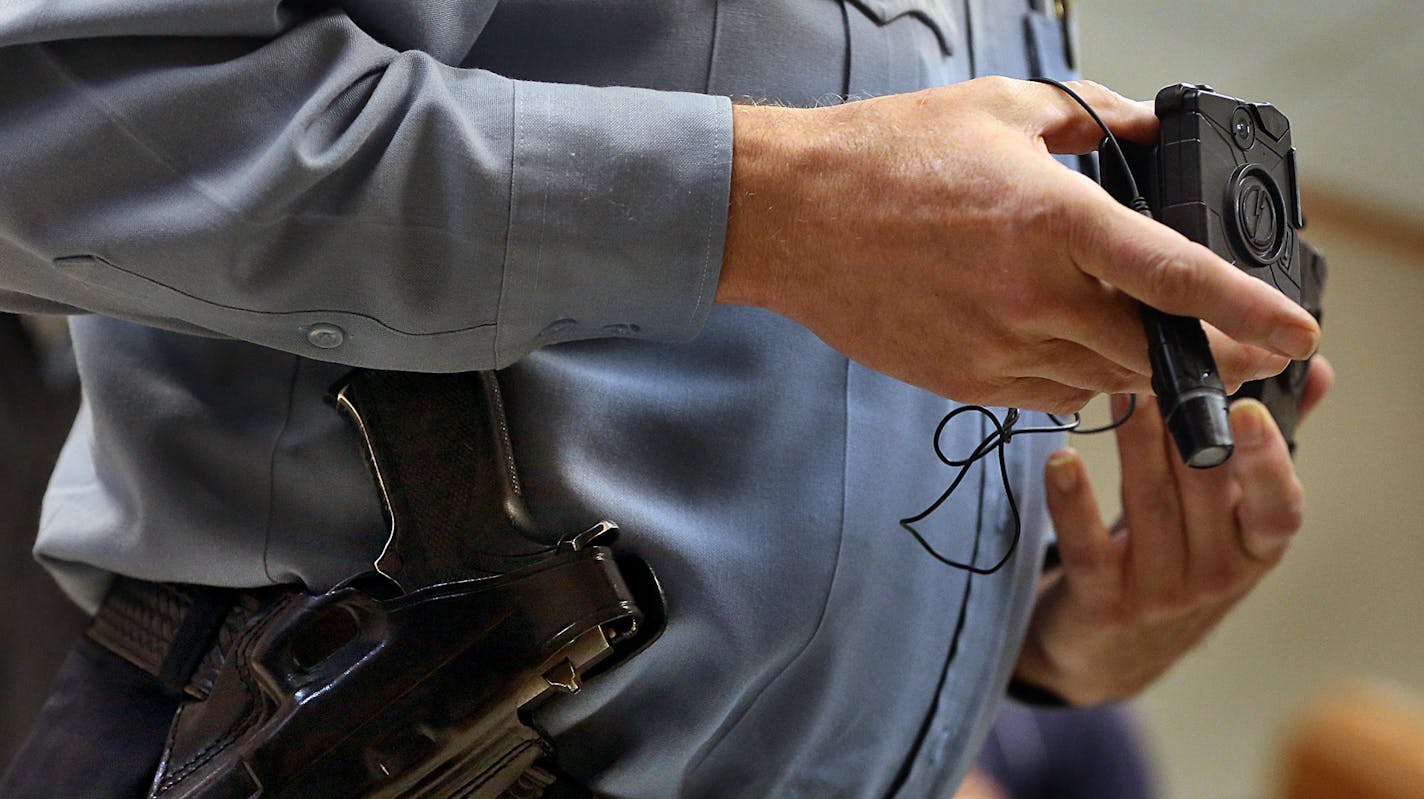 Minneapolis Police Lt. Greg Reinhardt displayed two of the body cameras that will be tested by the department. Both cameras will record 9.5 hours of video (non HD) and are mad by Taser. One camera attaches to an officer&#xe2;&#x20ac;&#x2122;s body and is completely self-contained, while the other offers a more flexible option, with a thinner camera attached to a battery. ] JIM GEHRZ &#xe2;&#x20ac;&#xa2; jgehrz@startribune.com / Minneapolis, MN / November 7, 2014 / 1:00 PM / BACKGROUND INFORMATIO