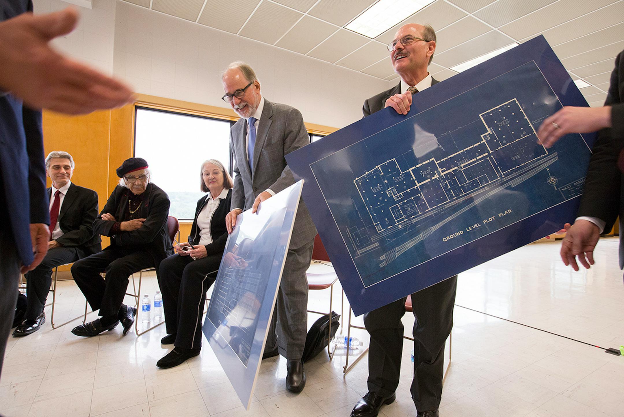 Vance Opperman, left, and Fane Opperman, sons of longtime West Publishing president Dwight Opperman, accept blueprints of the former West Publishing building during a tour of the building downtown St. Paul on Friday, May 29, 2015.