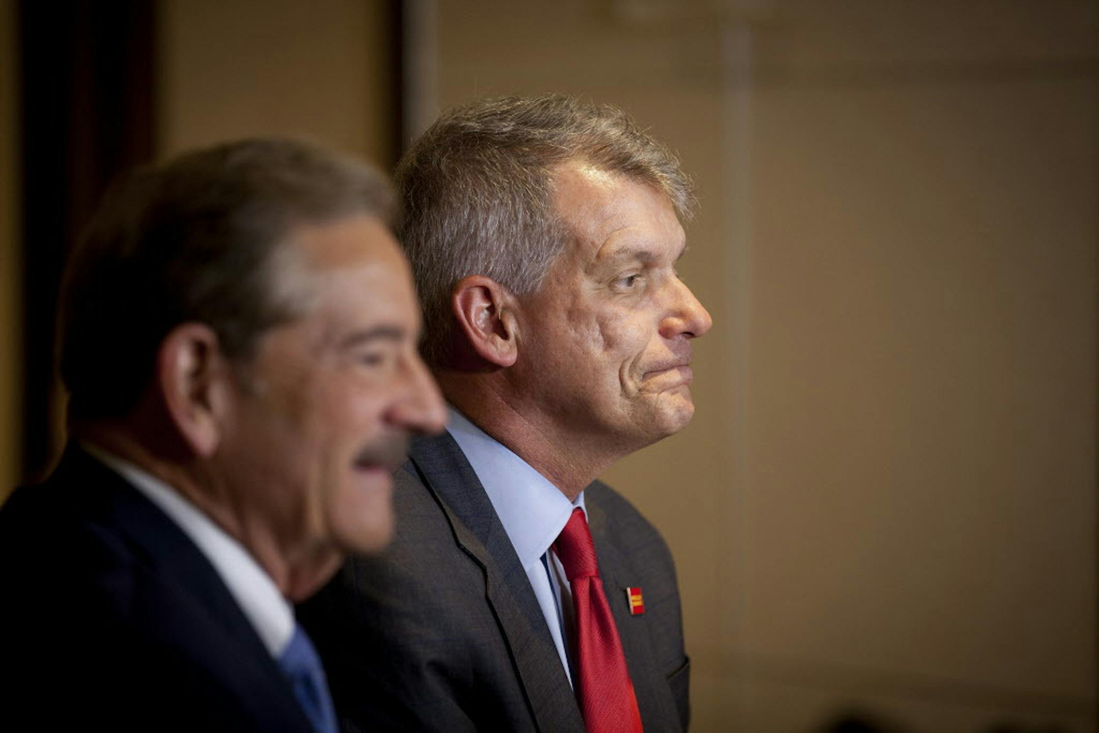 Tim Sloan, right, chief executive of Wells Fargo, and Stephen Sanger, chairman of the bank's board, left, talk with reporters after a shareholders meeting in Ponte Vedra Beach, Fla., April 25, 2017. Despite the turmoil that has engulfed Wells Fargo in the past year, shareholders voted Tuesday to re-elect all of the bankís 15 directors. But some of the board members edged in just barely. (Charlotte Kesl/The New York Times)