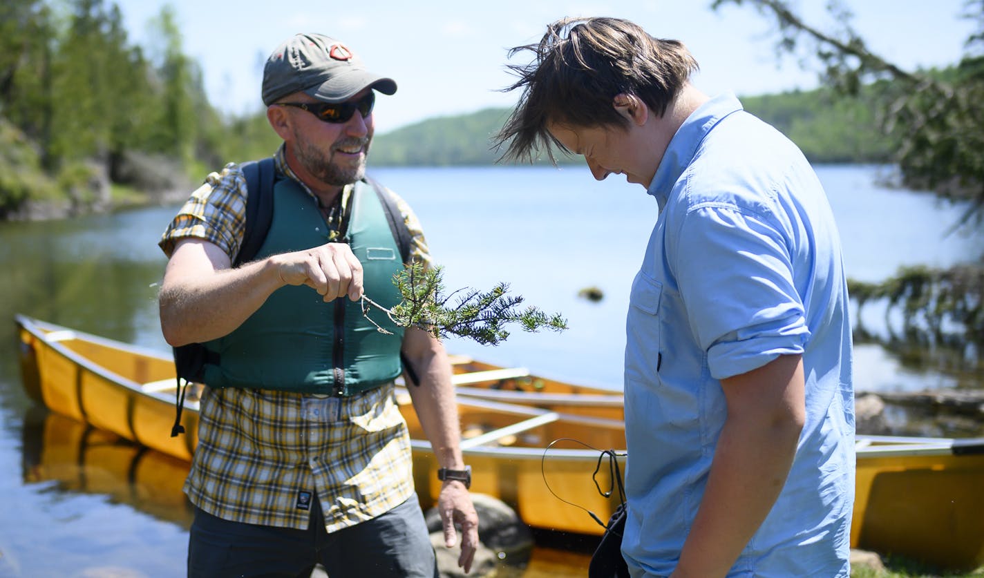 Tony Jones baptized his 14-year old son, Aidan, as a neophyte voyageur at the completion of the Height of Land Portage in the BWCA. ] Aaron Lavinsky ¥ aaron.lavinsky@startribune.com DAY 1 - Tony Jones, his 14-year old son Aidan, their friend Brad Shannon and Outdoors editor Bob Timmons embarked onto the Voyageurs Highway on Tuesday, June 11, 2019. Their path Tuesday took them from Gunflint Lake, to North Lake, through the Height of Land Portage eventually ending at a camp site on South Lake in t