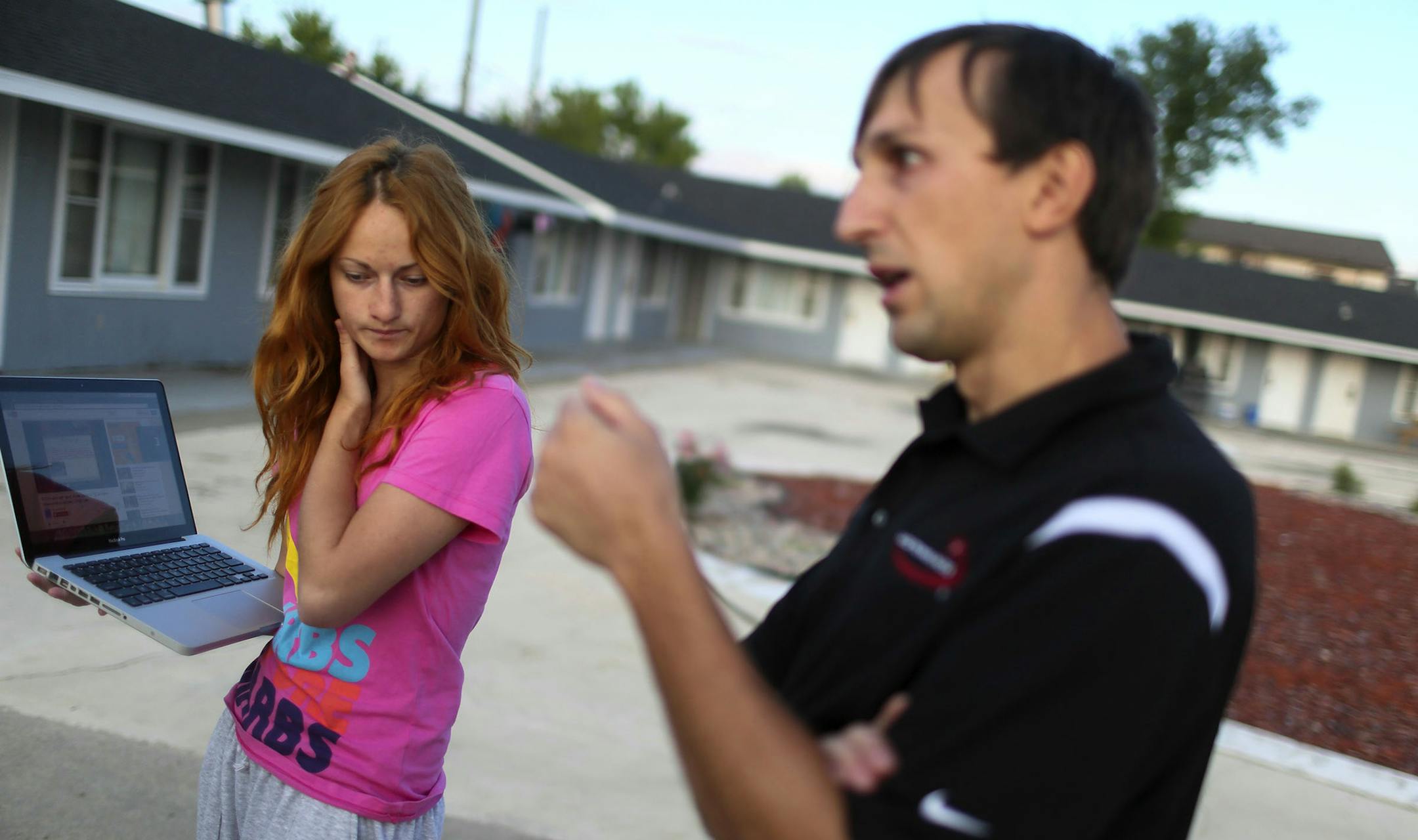 A group of mostly Ukrainian workers have come to Perham this summer for employment at KLN Enterprises, the family-owned parent company of Barrel O' Fun that also manufactures snack brands for other companies. Here, Slav Makukha, right, and his girlfriend Karina Babanina outside their temporary motel residence where they were skyping with Makukha's brother, who is living and working in Pennsylvania. Makukha and Babanina are temp employees of KLN in Perham and were waiting for their 11 p.m. shift
