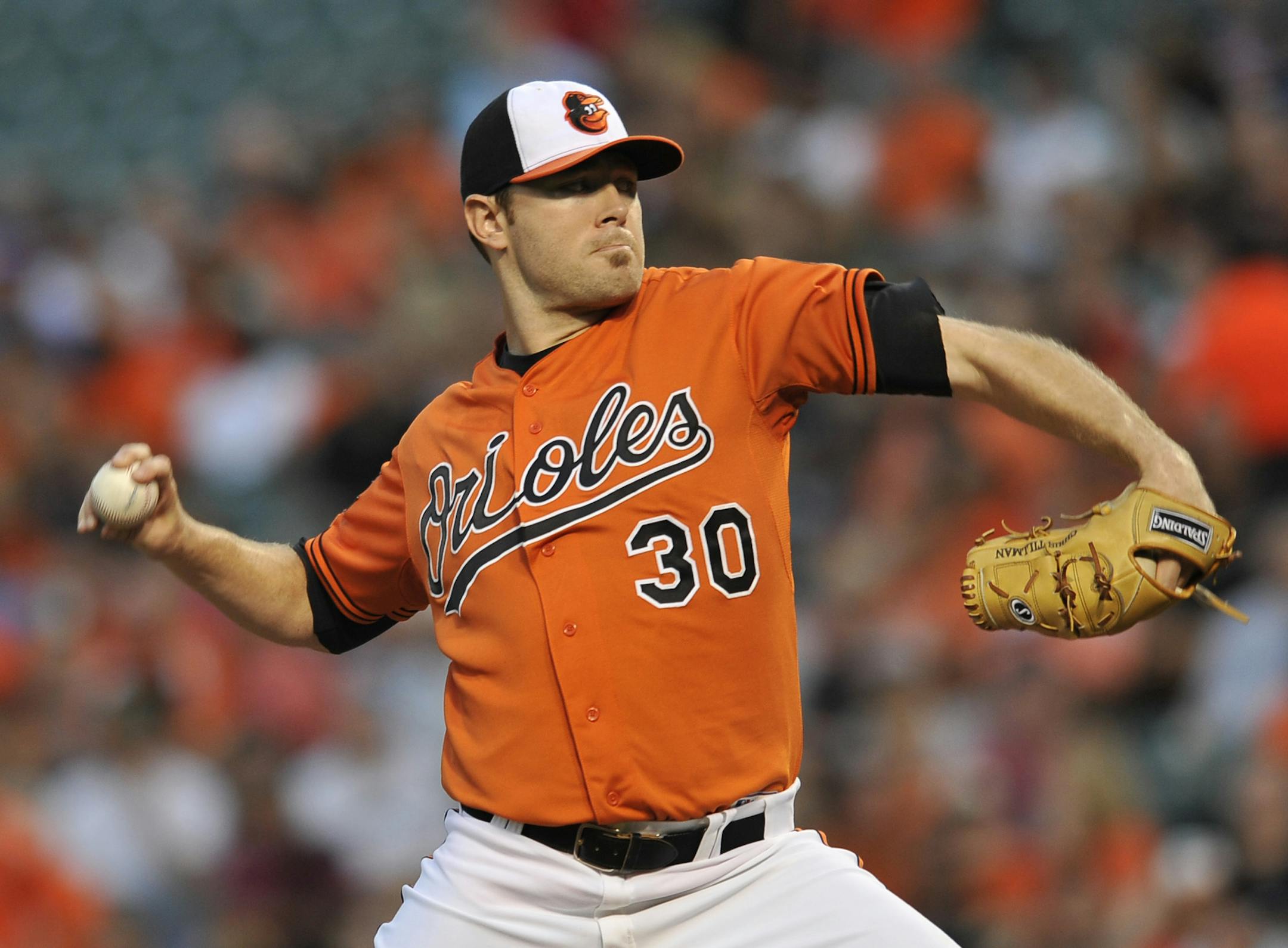 Baltimore Orioles starting pitcher Chris Tillman delivers against the Minnesota Twins in the first inning of a baseball game, Saturday, Aug. 30, 2014, in Baltimore.(AP Photo/Gail Burton)