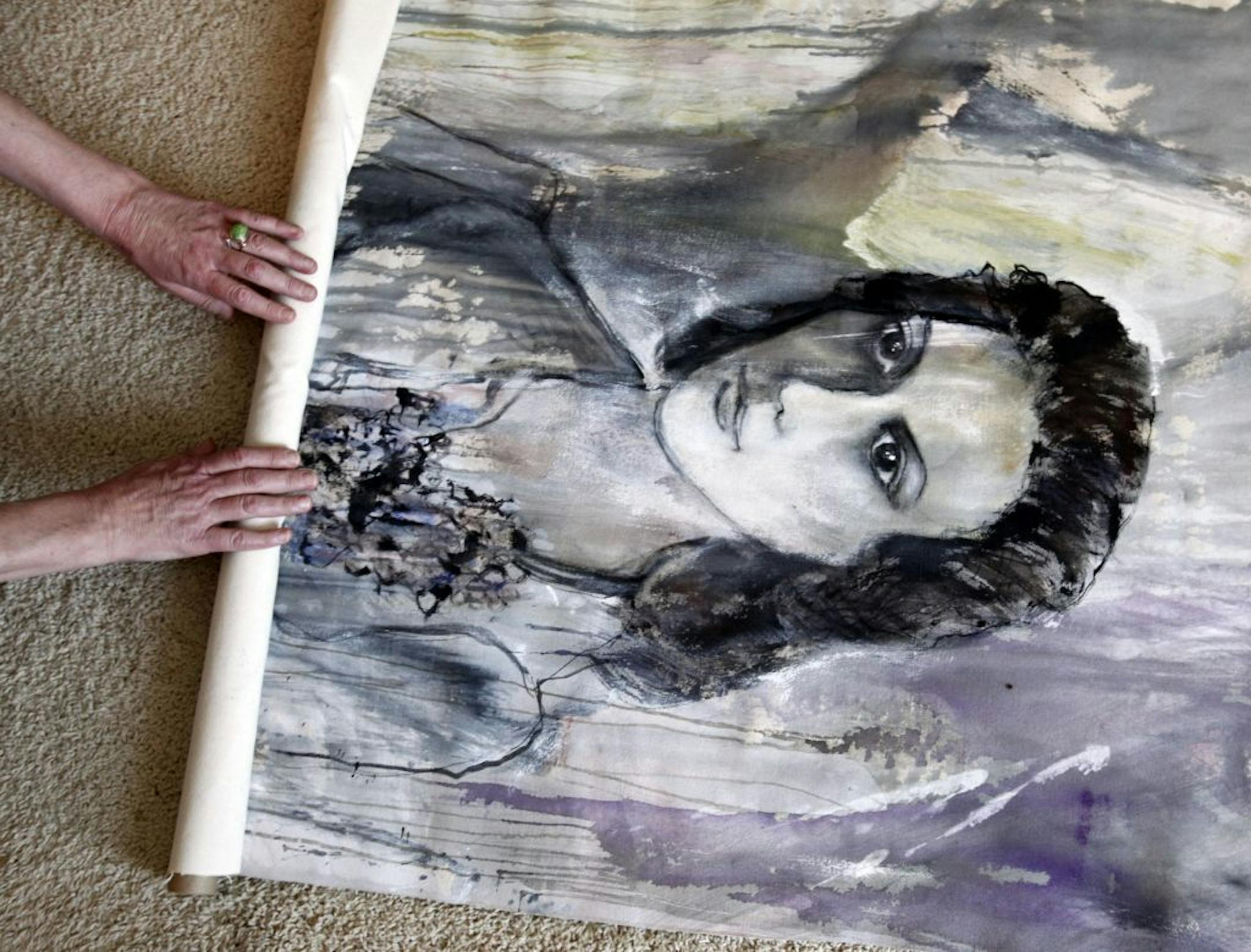 A painting of Alphie Cain, 89, in her apartment Thursday, Aug. 11, in St. Louis Park, MN, being rolled up by her daughter.