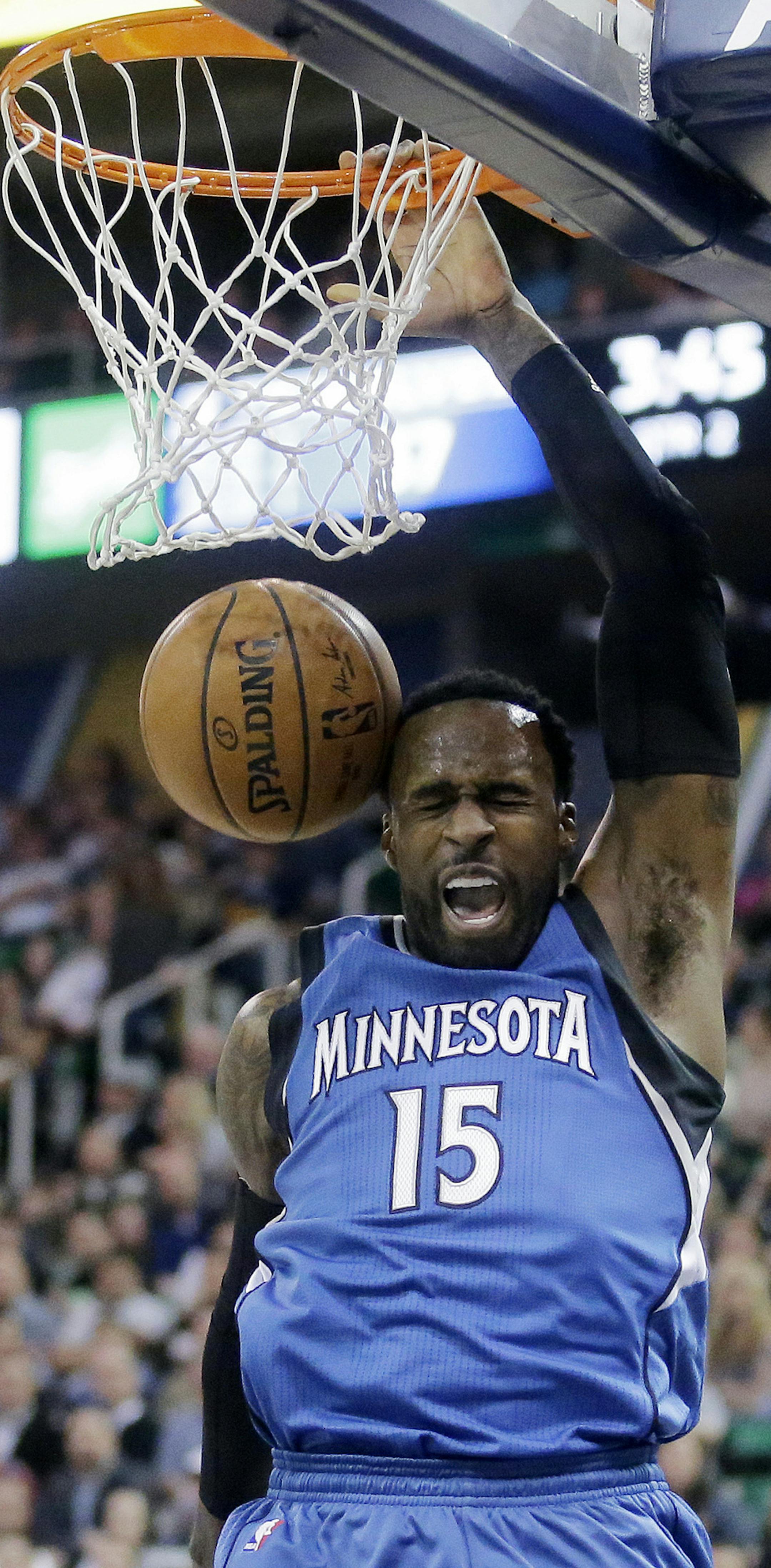 Minnesota Timberwolves forward Shabazz Muhammad (15) dunks during the first half in an NBA basketball game against the Utah Jazz, Wednesday, March 1, 2017, in Salt Lake City. (AP Photo/Rick Bowmer)