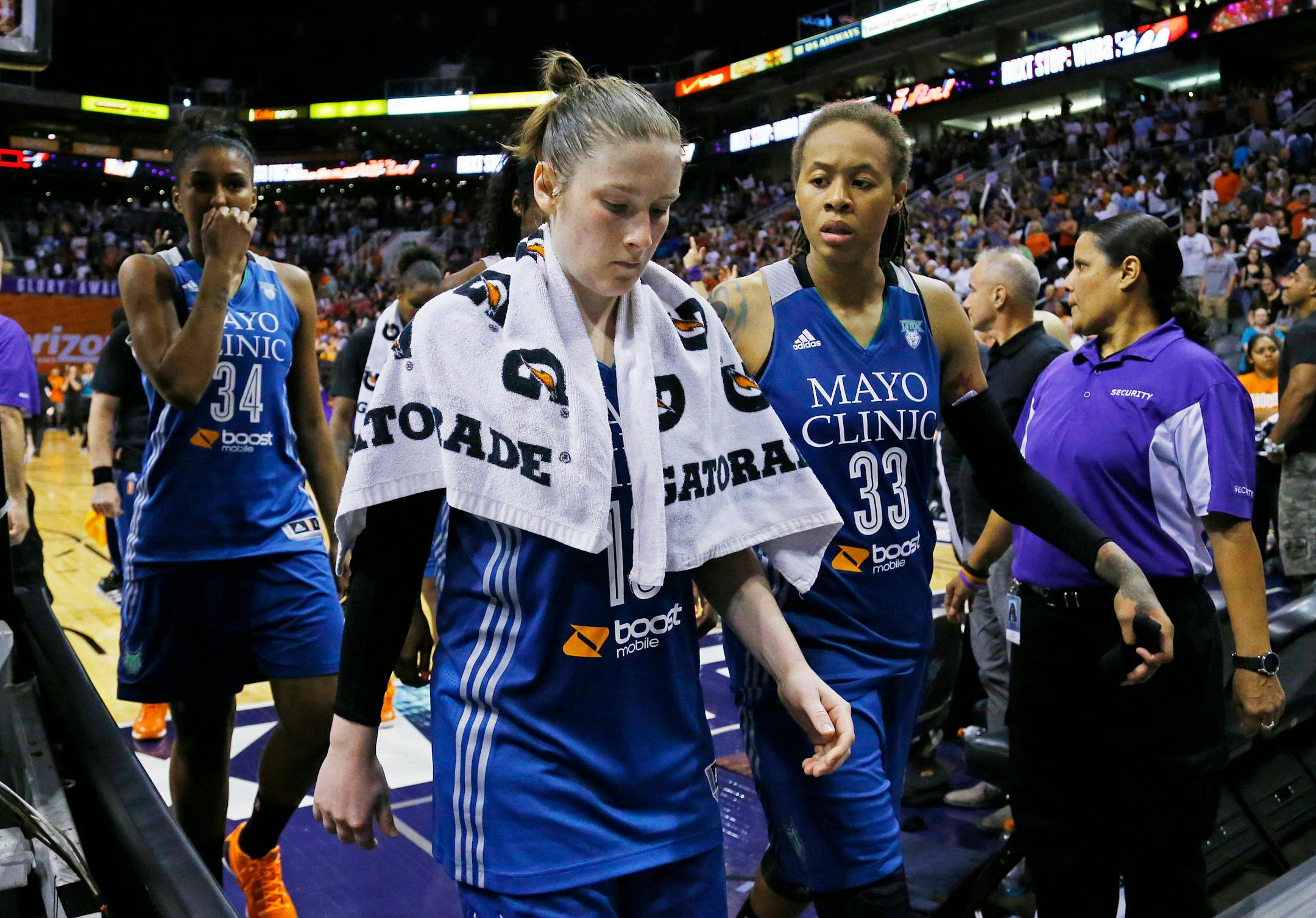 Minnesota Lynx forward Damiris Dantas (34) Lindsay Whalen and Seimone Augustus leave the court after their loss to the Phoenix Mercury celebrate their 96-78 win over the Minnesota Lynx in game 3 of the WNBA Western Conference finals Tuesday, Sept. 2, 2014 in Phoenix Ariz.
