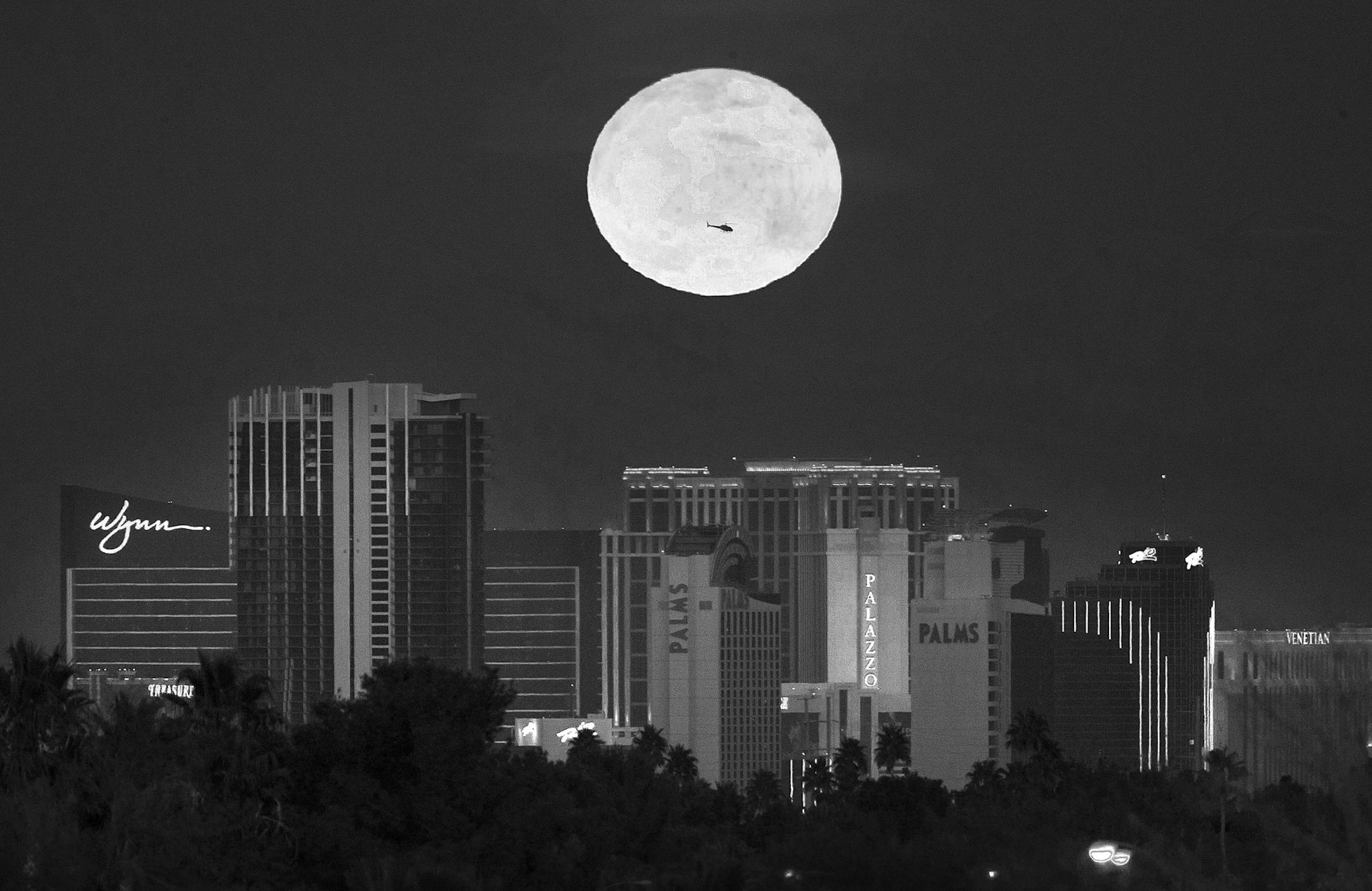 The first supermoon of the new year rises above the Vegas Strip on Monday, Jan. 1, 2018. A supermoon occurs when the moon is full at the same time it reaches perigee, or that point in the moon's orbit when it is closest to Earth. (Richard Brian/Las Vegas Review-Journal via AP)
