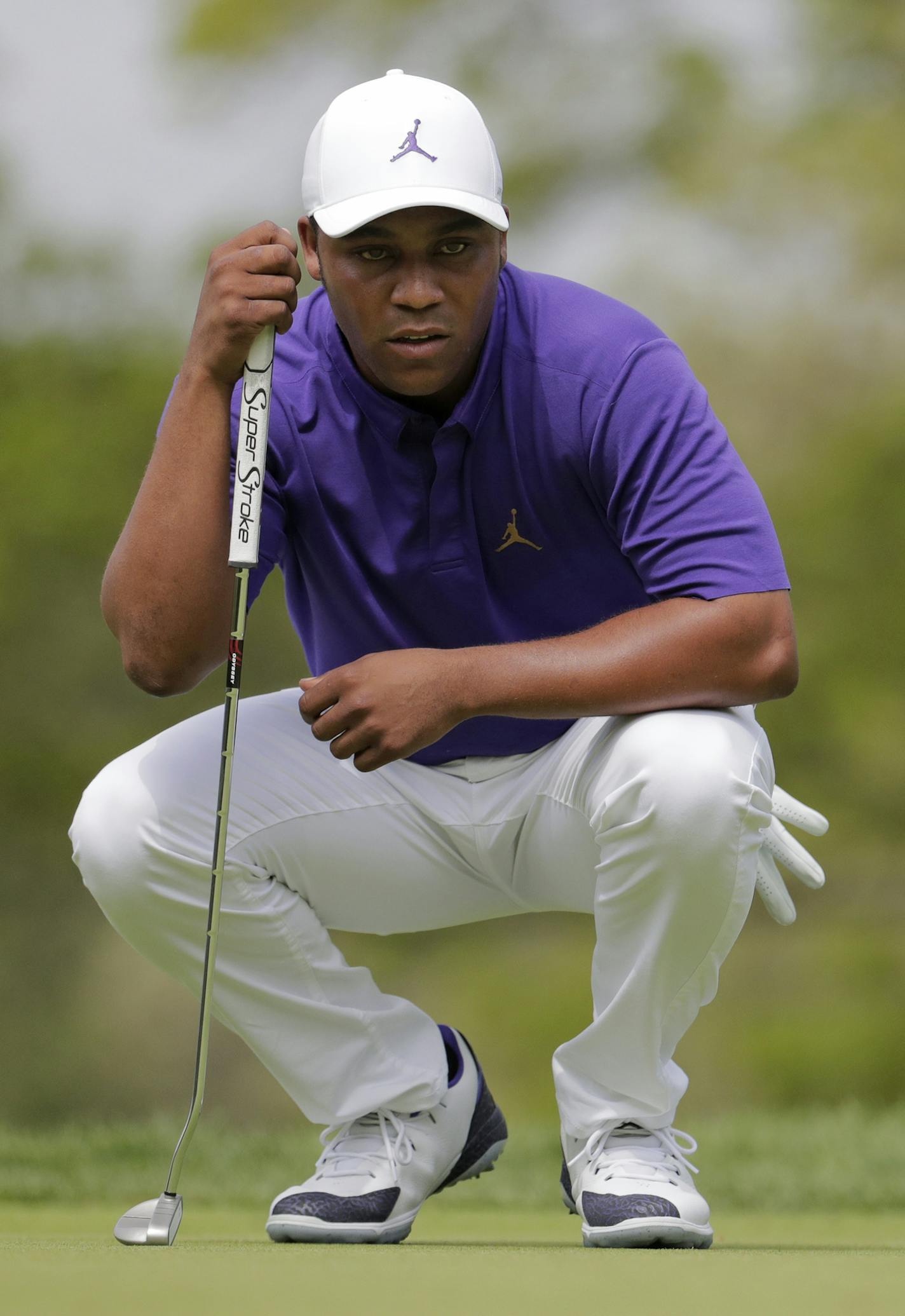 Harold Varner III lines up a putt on the third hole during the final round of the PGA Championship golf tournament, Sunday, May 19, 2019, at Bethpage Black in Farmingdale, N.Y. (AP Photo/Julio Cortez)