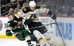 Charlie Coyle worked the puck against the Wild's Brad Hunt on Thursday.