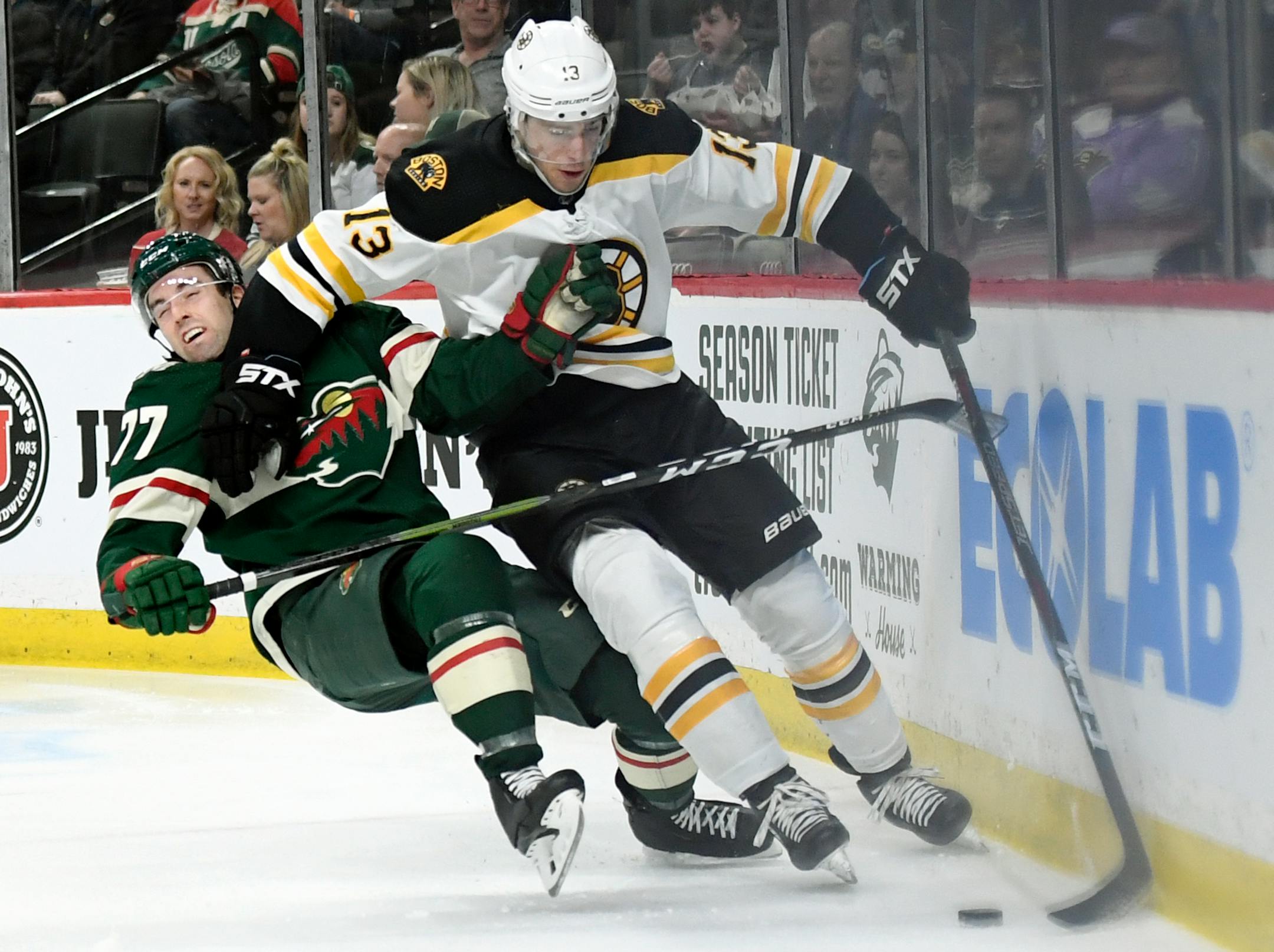 Charlie Coyle worked the puck against the Wild's Brad Hunt on Thursday.