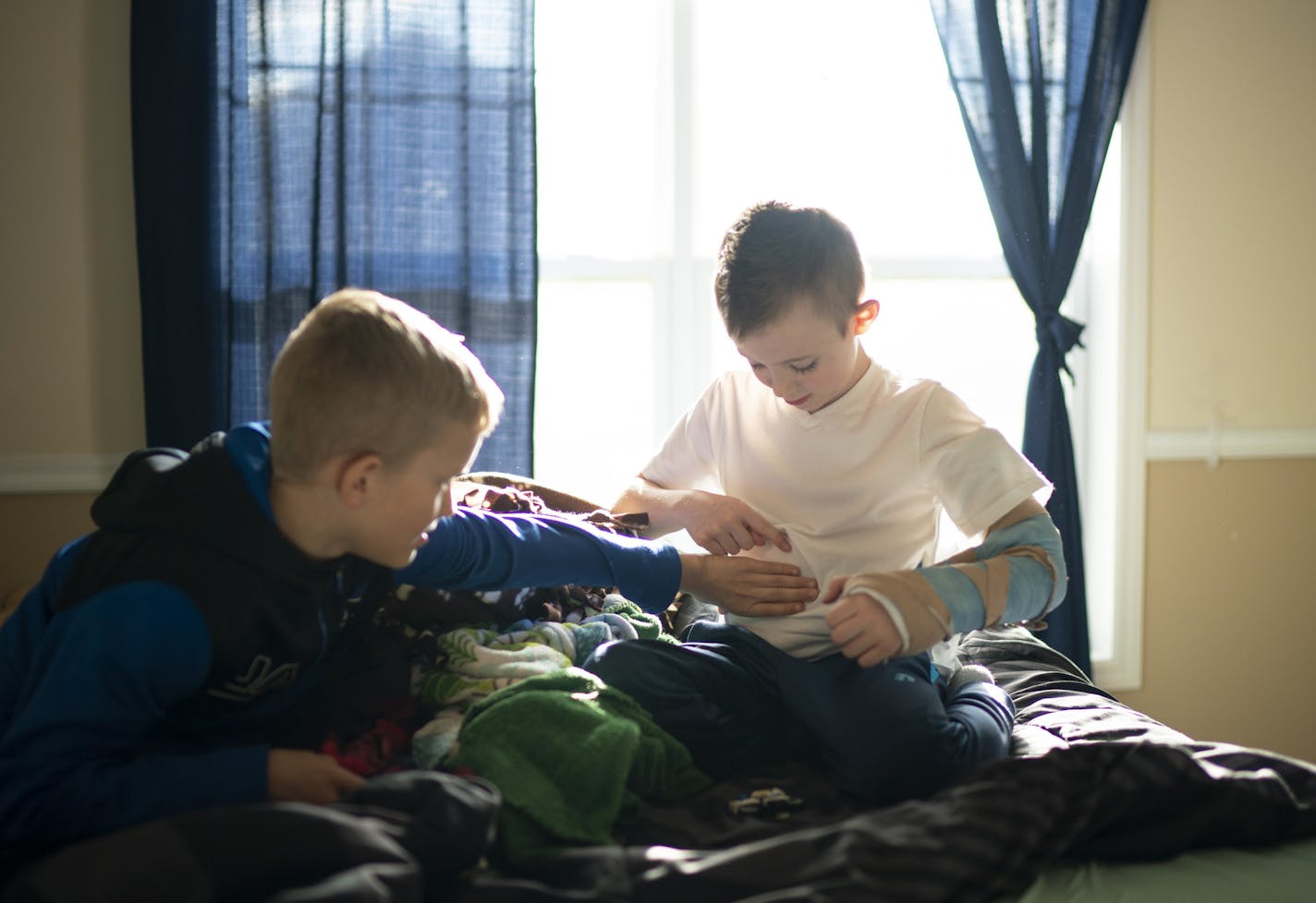 A week out from surgery in California on his left arm, Quinton Hill played with his buddy and neighbor, Max Joyce, Thursday afternoon. Quinton was showing Max the brace around his waist that is connected to his arm to stabilize it. ] JEFF WHEELER &#x2022; jeff.wheeler@startribune.com Quinton Hill, 7, is one of several children in the state afflicted with AFM and polio-like symptoms. He was photographed at home in Lakeville Thursday afternoon, April 18, 2019.