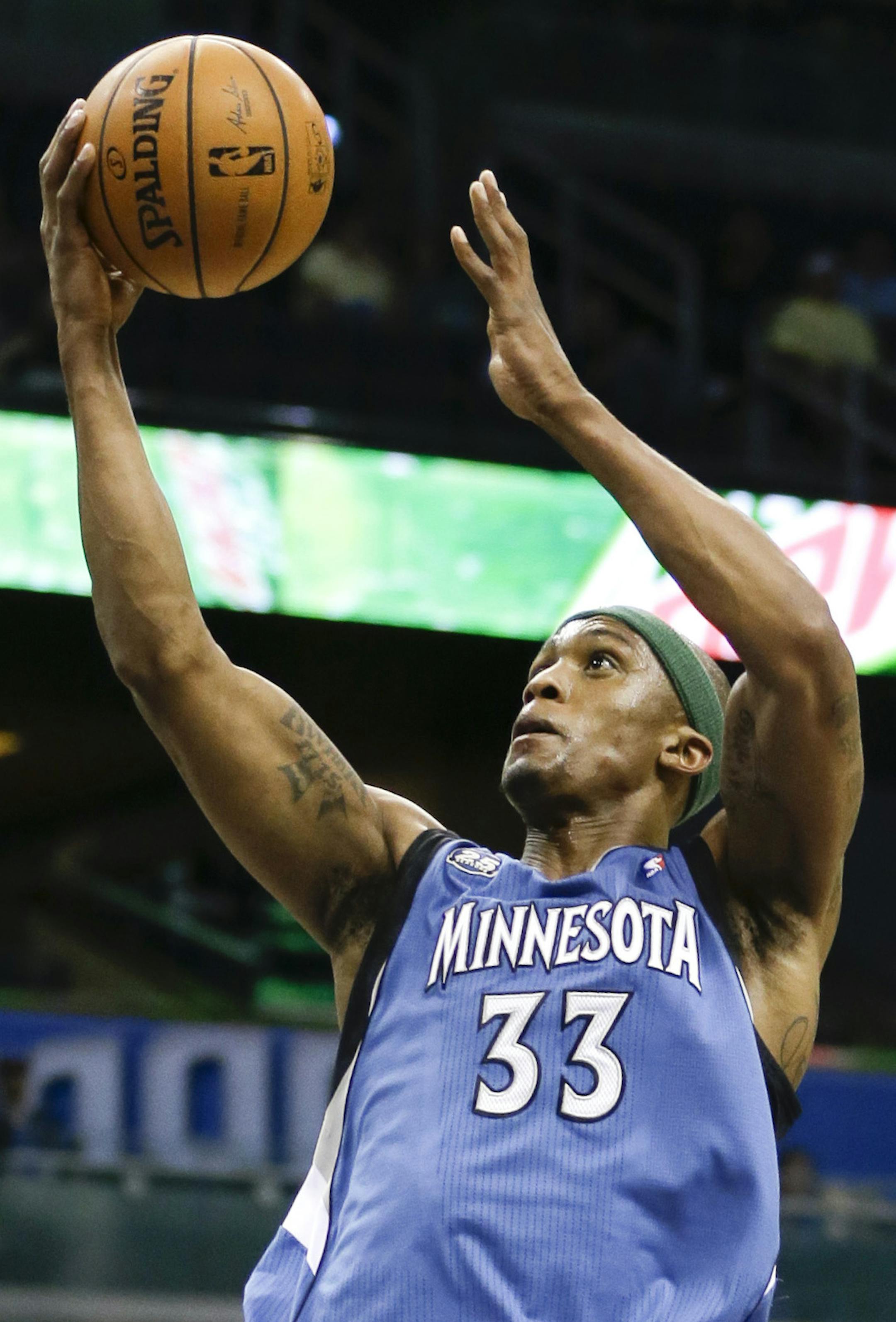 Minnesota Timberwolves' Dante Cunningham (33) gets past Orlando Magic's Jameer Nelson for a basket during the first half of an NBA basketball game in Orlando, Fla., Saturday, April 5, 2014. (AP Photo/John Raoux)
