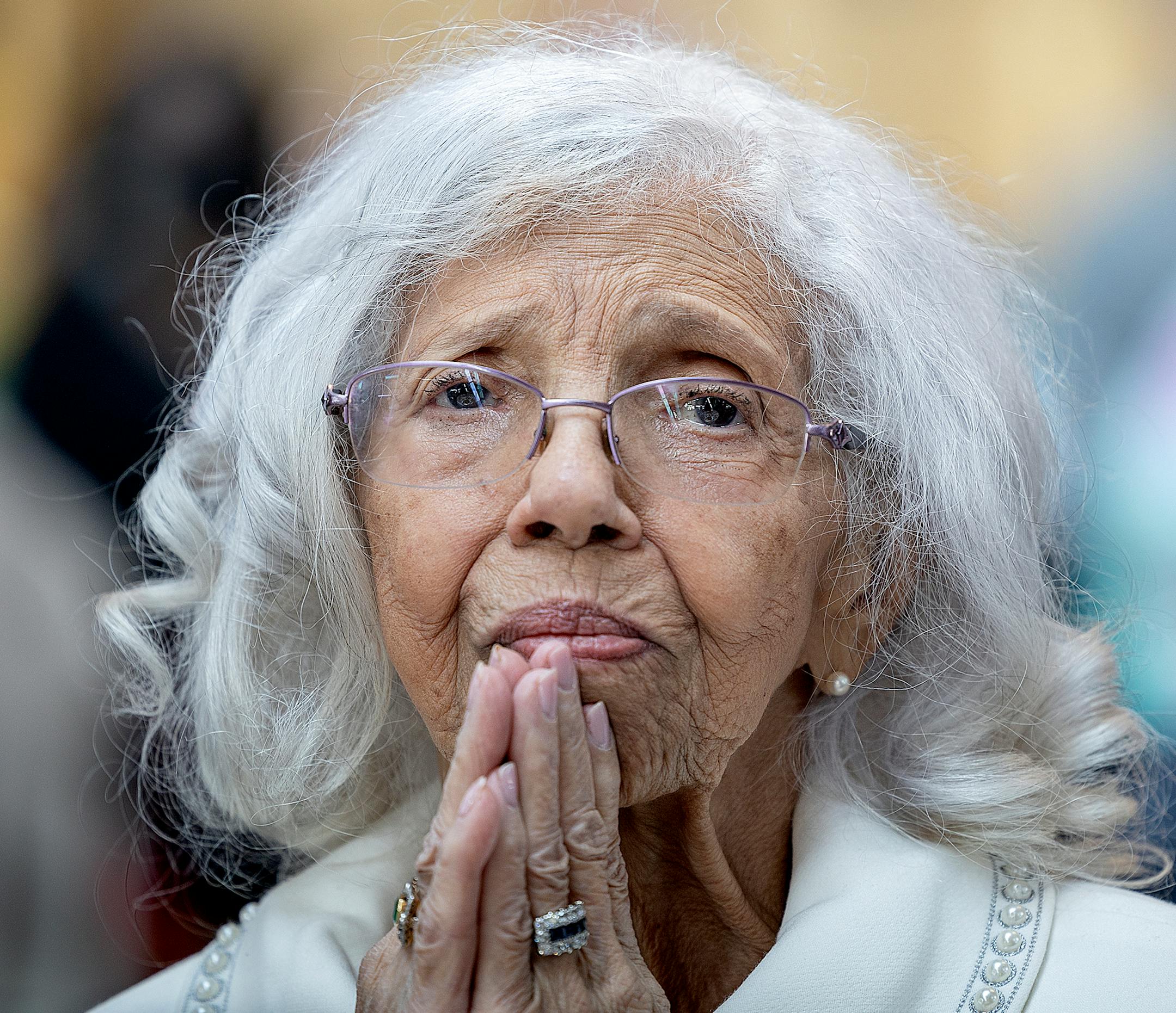 Josie R. Johnson listens as Lt. Governor Peggy Flanagan speaks about her during a ceremony.