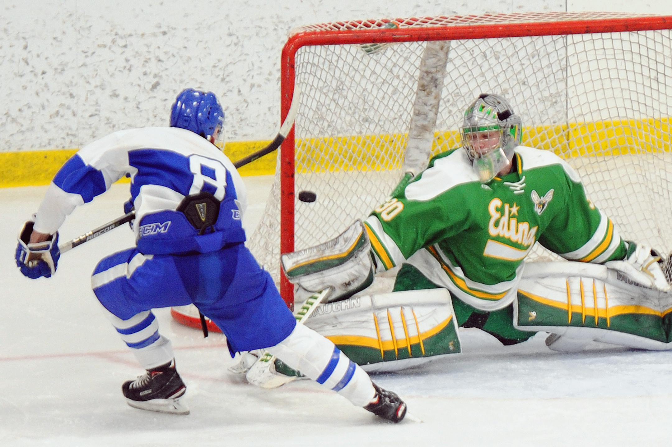 Minnetonka’s Luke Loheit (8) fires a shot past Edina goaltender Garrett Mackay during the third period of their Lake Conference game Saturday afternoon at the Pagel Activity Center. The No. 2-ranked Skippers beat the top-rated Hornets 5-3.