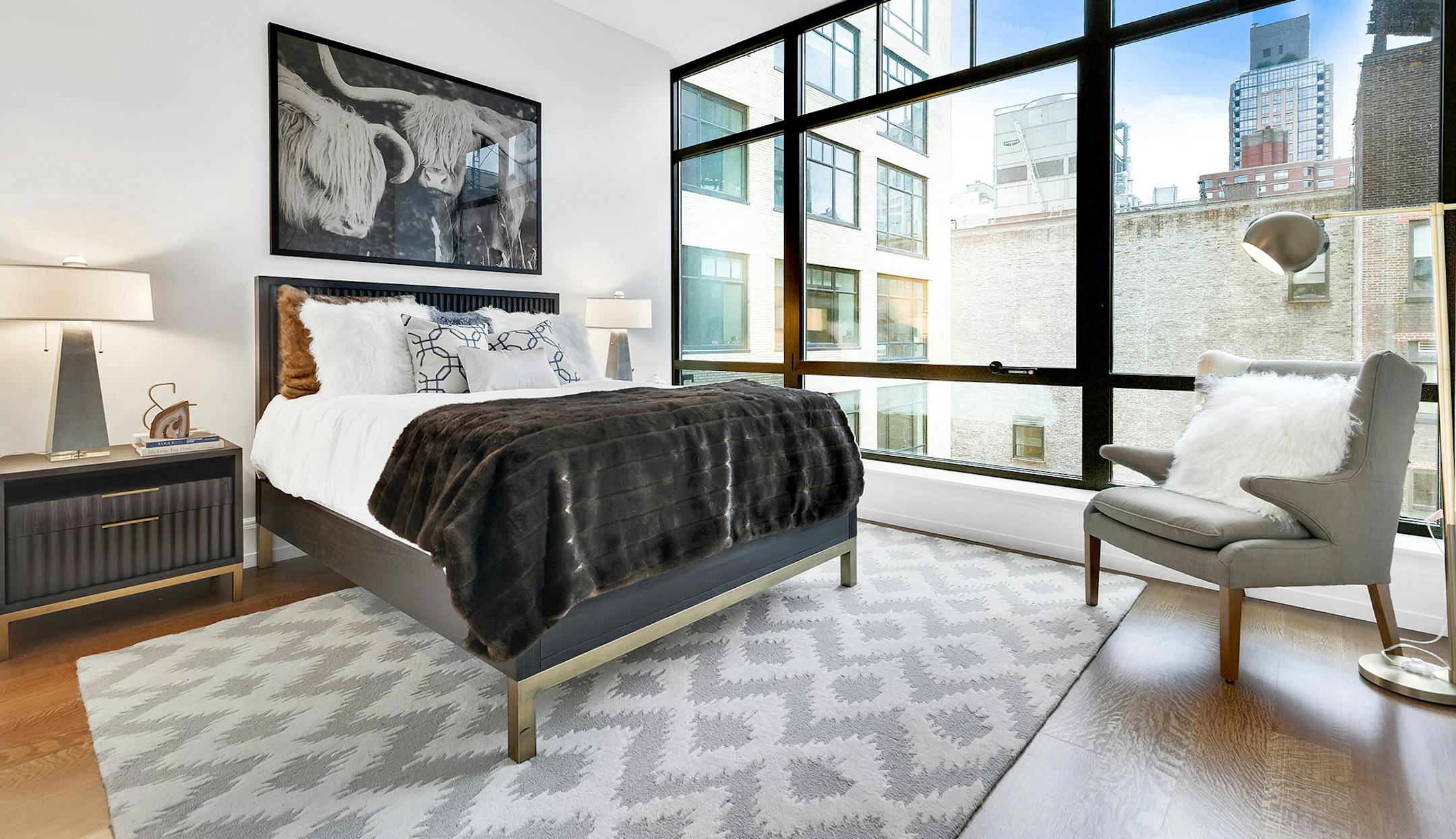 Black furniture including a black bed and night tables creates a feeling of luxury in this bedroom.