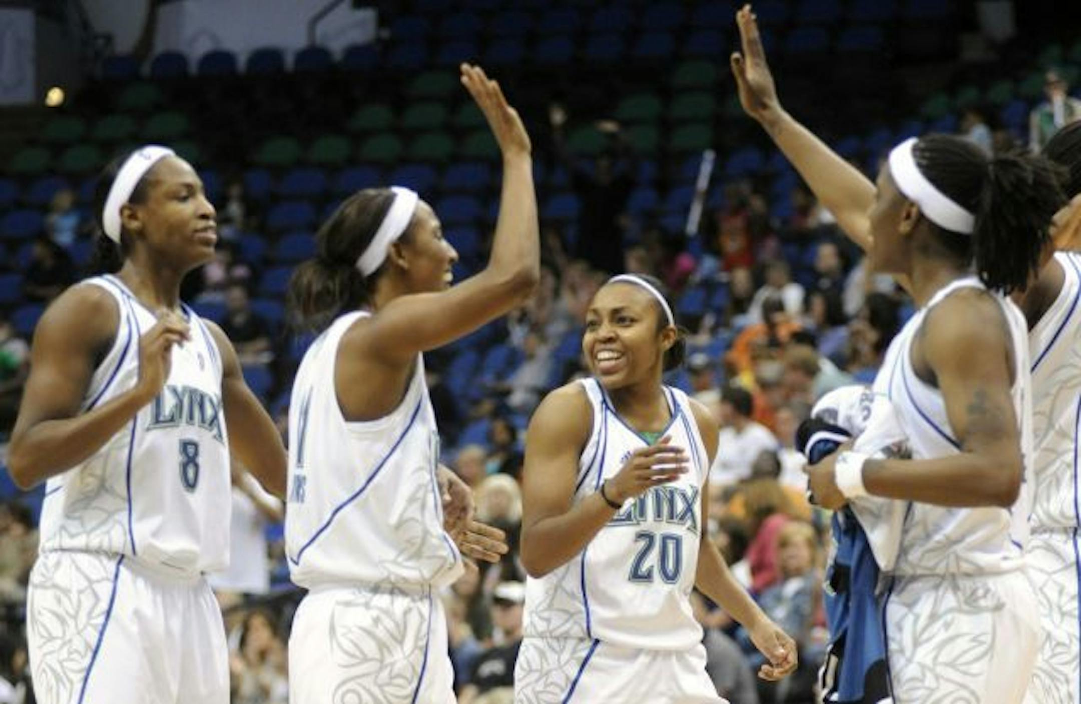 From left to right, Minnesota Lynx's Rashanda McCants (8), Candice Wiggins, Renee Montgomery (20) and Roneeka Hodges celebrate as they return to the bench for a time out during the third quarter of a WNBA basketball game against Sacramento Monarchs in Minneapolis on Friday, Aug. 28, 2009. The Lynx defeated the Monarchs 100-95.