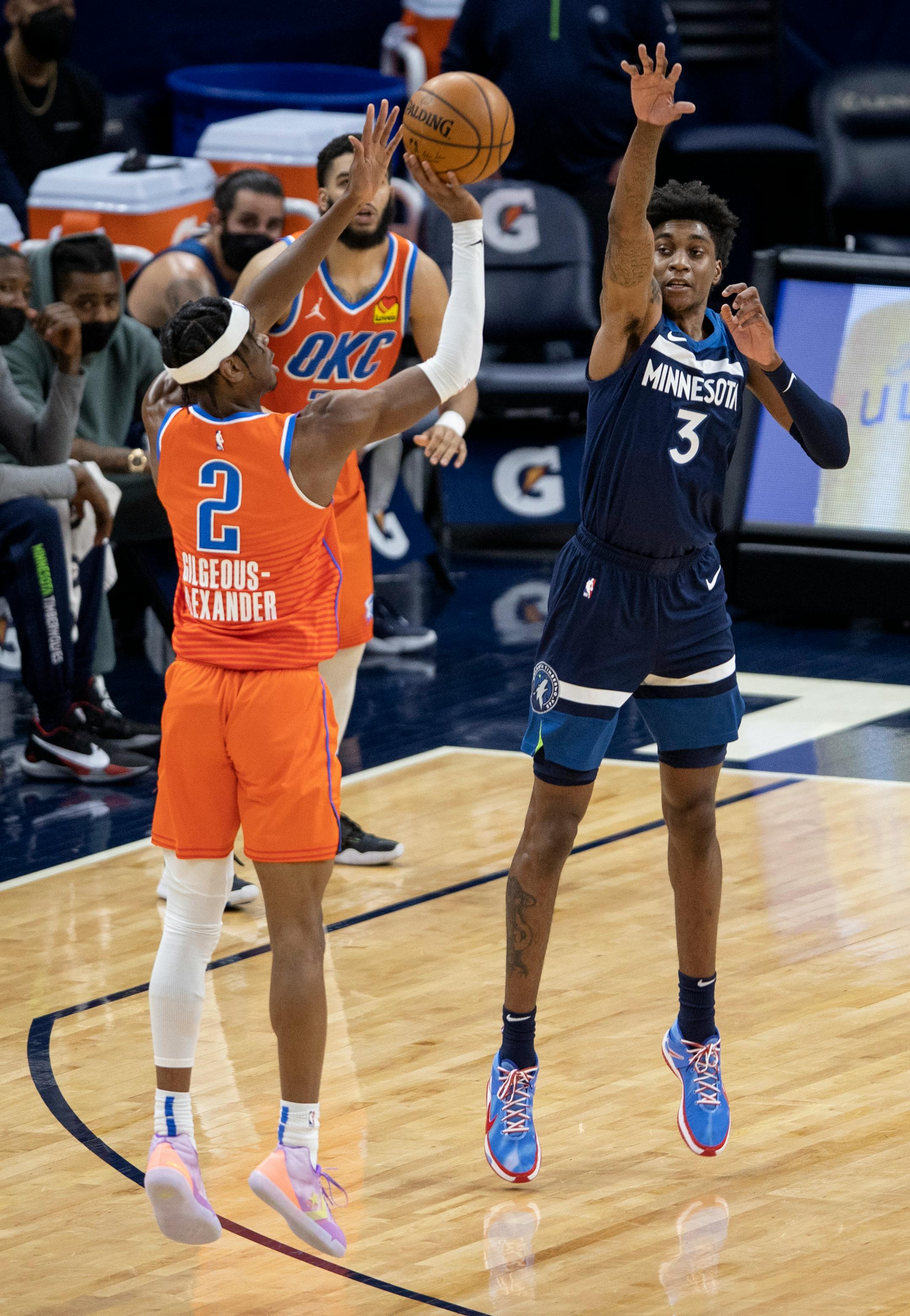 Shai Gilgeous Alexander (2) of the Oklahoma City shot a three pointer while defended by Jaden McDaniels (3) of the Minnesota Timberwolves in the third quarter.
