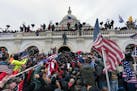 Pro-Trump supporters push back against police at the United States Capitol Building in Washington, D.C., on Jan. 6. Six Capitol Police have been suspe