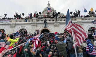Pro-Trump supporters push back against police at the United States Capitol Building in Washington, D.C., on Jan. 6. Six Capitol Police have been suspe