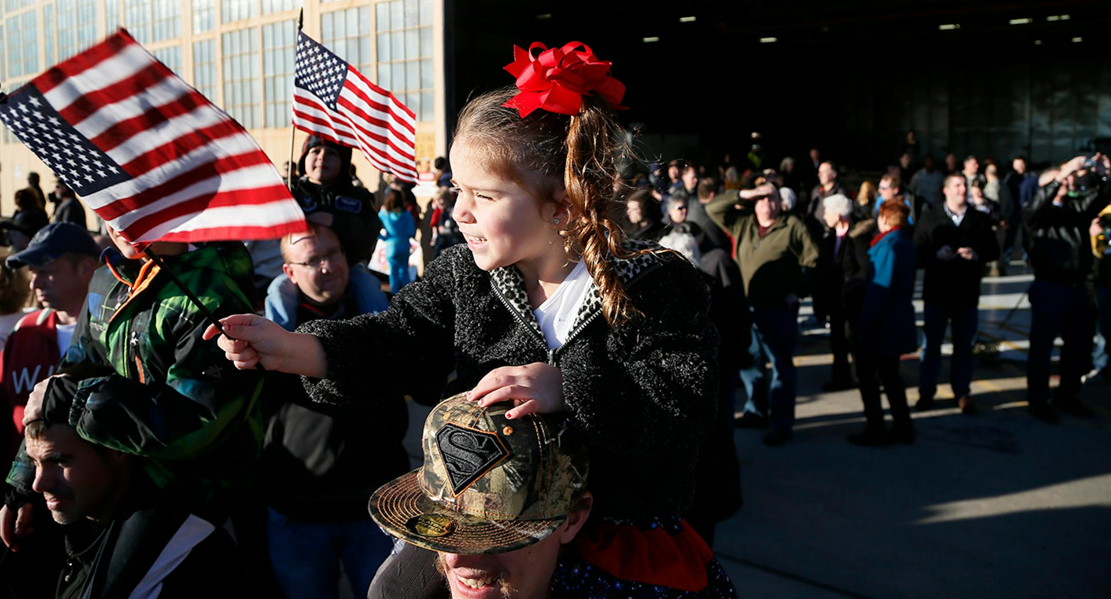 Judah Leier held his 3-year old daughter Aubree Leier on his shoulders, they were waving to her uncle Benjamin Rettmann who returned home Sunday. Families gather for the arrival of the more than 100 Airmen and three C-130 H3 Hercules aircraft from the 934th Airlift Wing, Air Force Reserve, return from their deployment to Southwest Asia after their four-month tour of duty. Sunday January 18, 2015 Minneapolis, MN.] Jerry Holt/ Jerry.Holt@Startribune.com