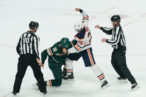 The Wild's Jordan Greenway (18) and the Oilers' Darnell Nurse (25) got into a brawl in the second period Thursday night.