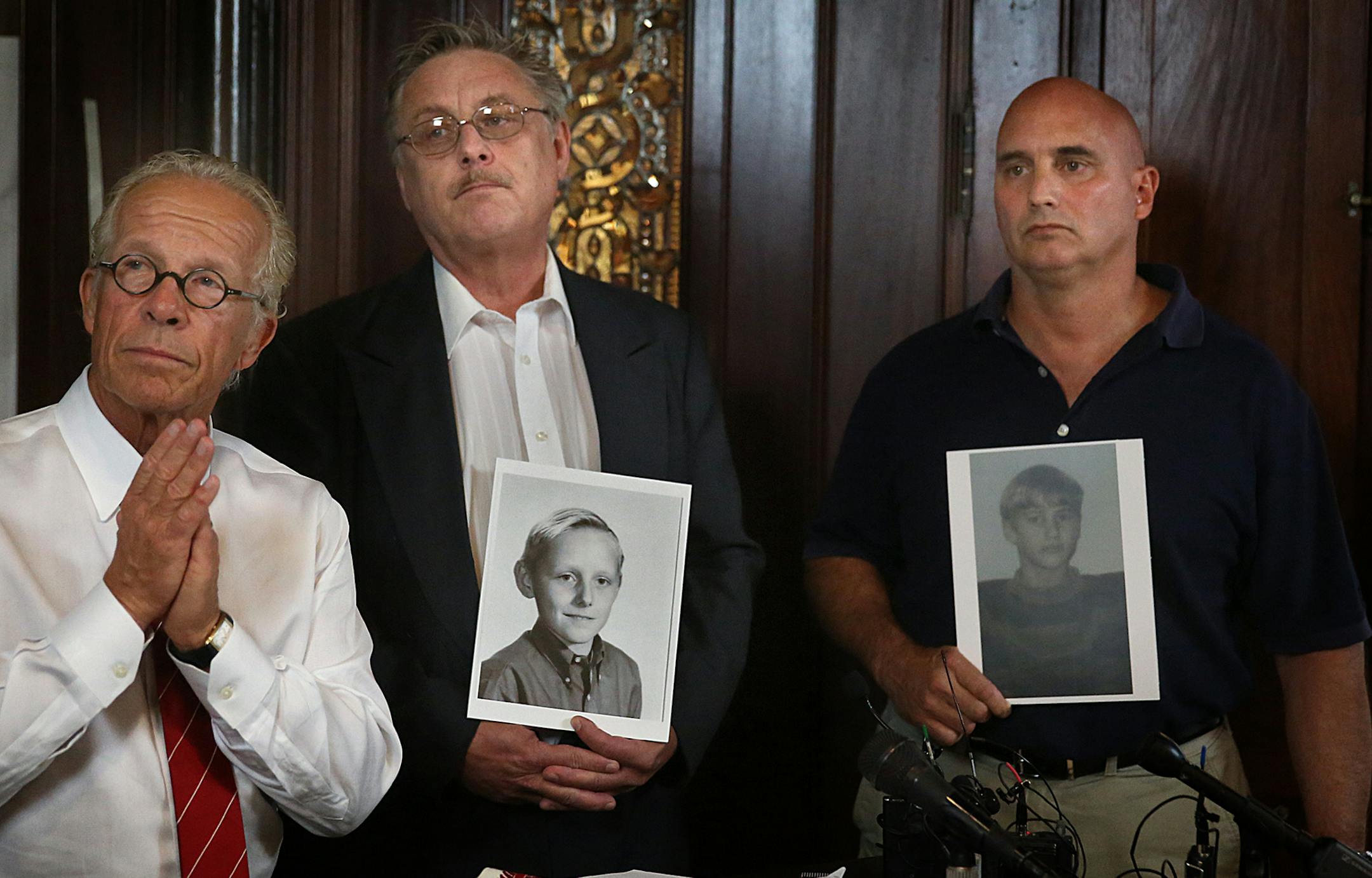 Former Boy Scouts Steven Josephson (middle) and David Lundquist (right), who allege they were abused by scout leaders, held photographs of themselves as children during a news conference with attorney Jeff Anderson (left). Anderson announced two new sex abuse lawsuits against Boy Scouts of America, the first ever public nuisance claims against the organization. ] JIM GEHRZ ï james.gehrz@startribune.com / St. Paul, MN / July 9, 2015 / 1:00 PM ñ BACKGROUND INFORMATION: Two new lawsuits i