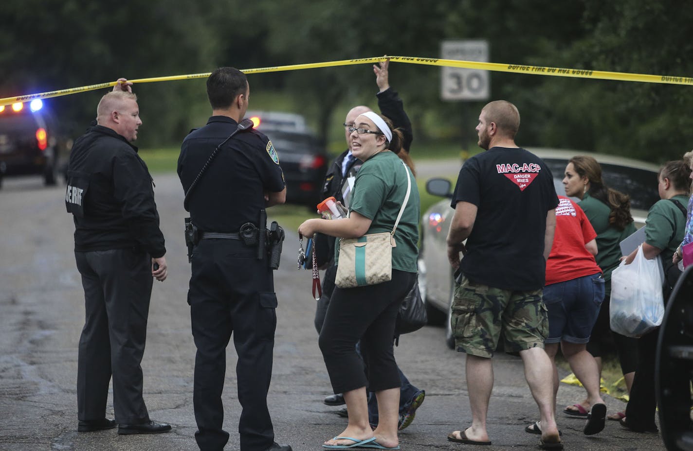 Following Police involved shooting outside the Learning Lodge Day Care Center day workers are led back to their cars near the crime scene Thursday Aug. 28, 2014, in Ramsey, MN.] (DAVID JOLES/STARTRIBUNE) djoles@startribune Police involved shooting outside the Learning Lodge Day Care Center in Ramsey, MN.