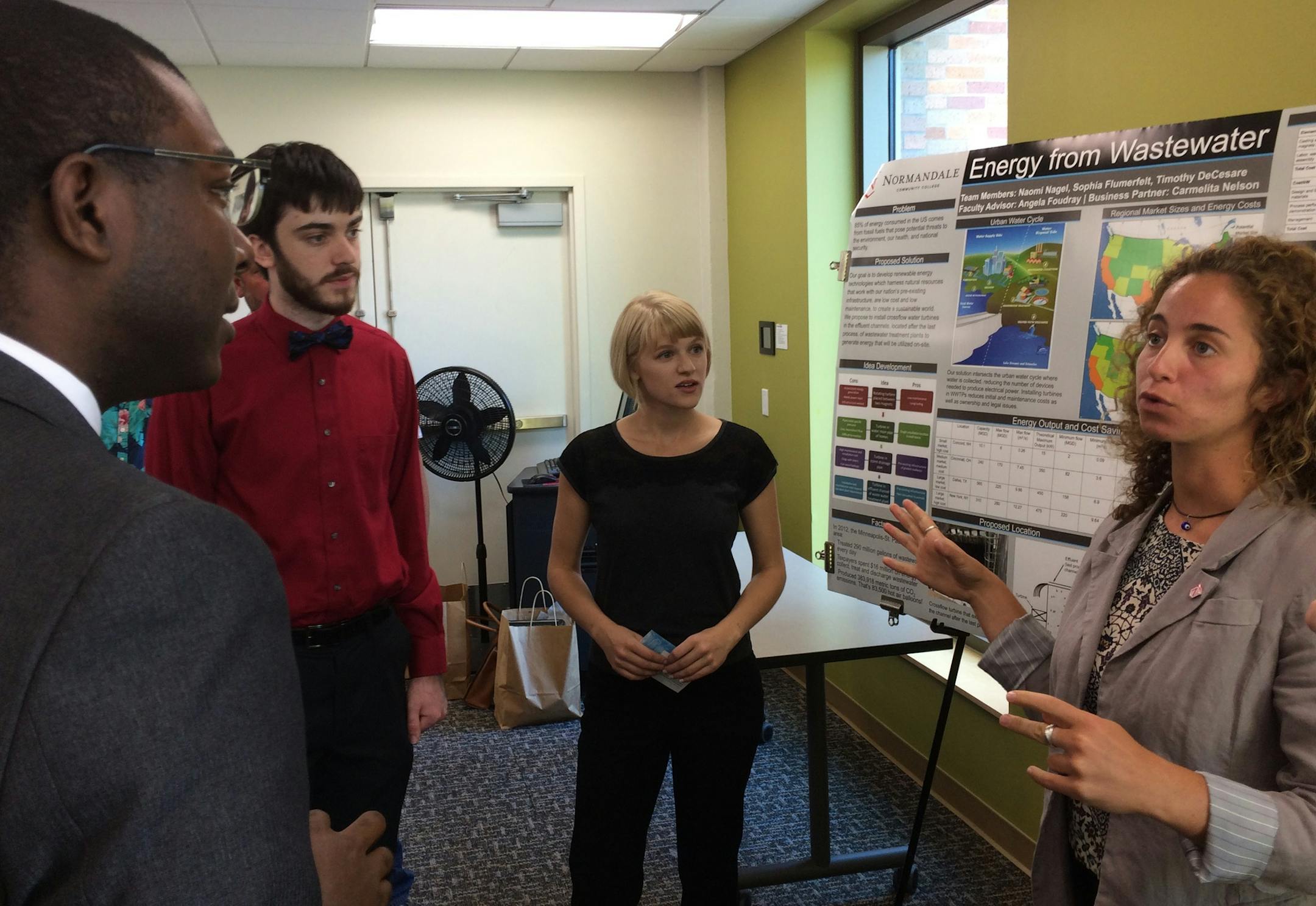 At a reception Wednesday, Normandale Community College sutdents (from right) Sophia Flumerfelt, Naomi Nagel and Tim DeCesare discussed their award-winning energy generation project with Garrison McMurtrey of U.S. Sen. Amy Klobuchar's office.